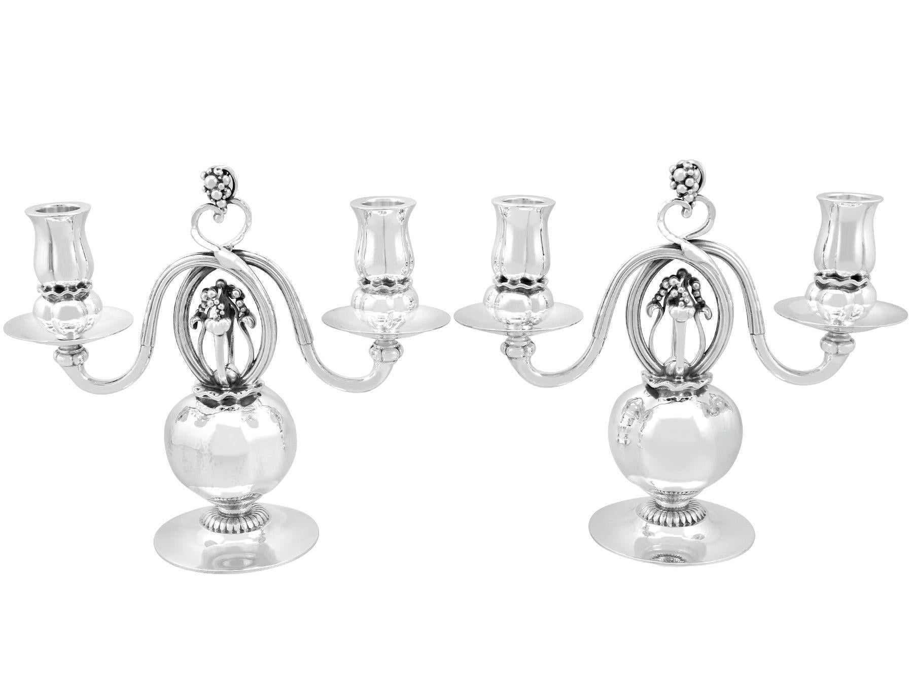 A magnificent, fine and impressive, rare pair of antique Danish sterling silver two light Pomegranate pattern candelabra made by Georg Jensen; an addition to our ornamental silverware collection

These magnificent and rare antique Danish cast