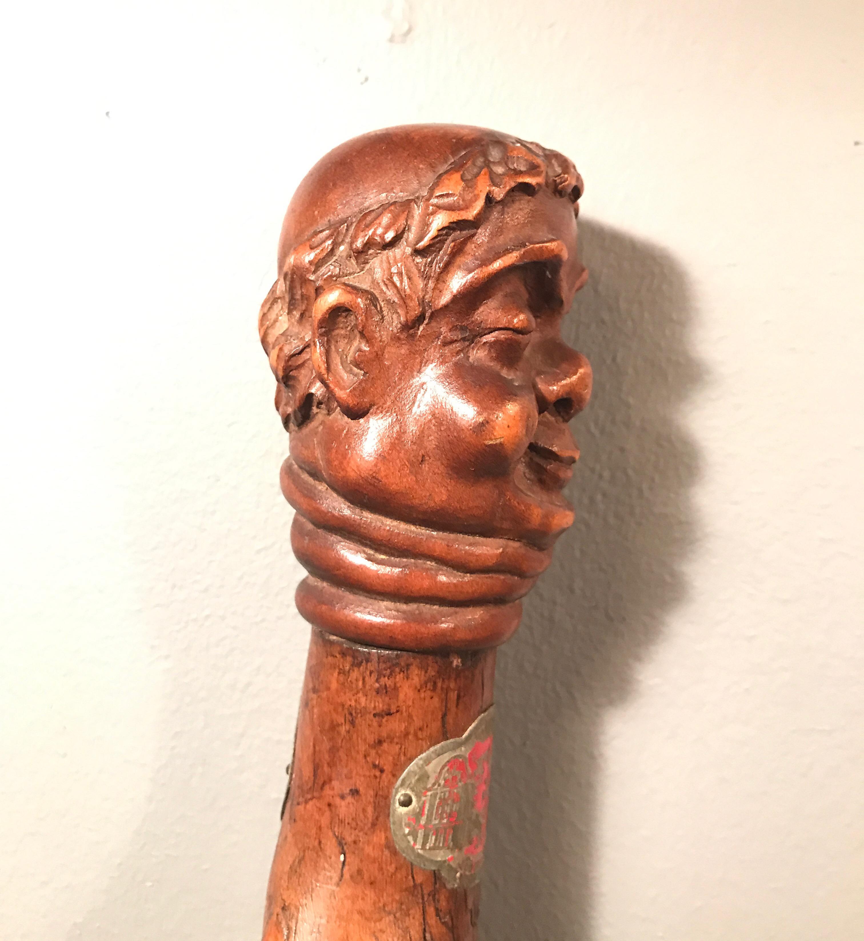 Antique walking stick dated 1836 and made in Denmark 
Carved out of a beautiful piece of fruitwood 
Could very well have been from a monastery 
Decorated with tin badges from European towns
Such a unique piece.