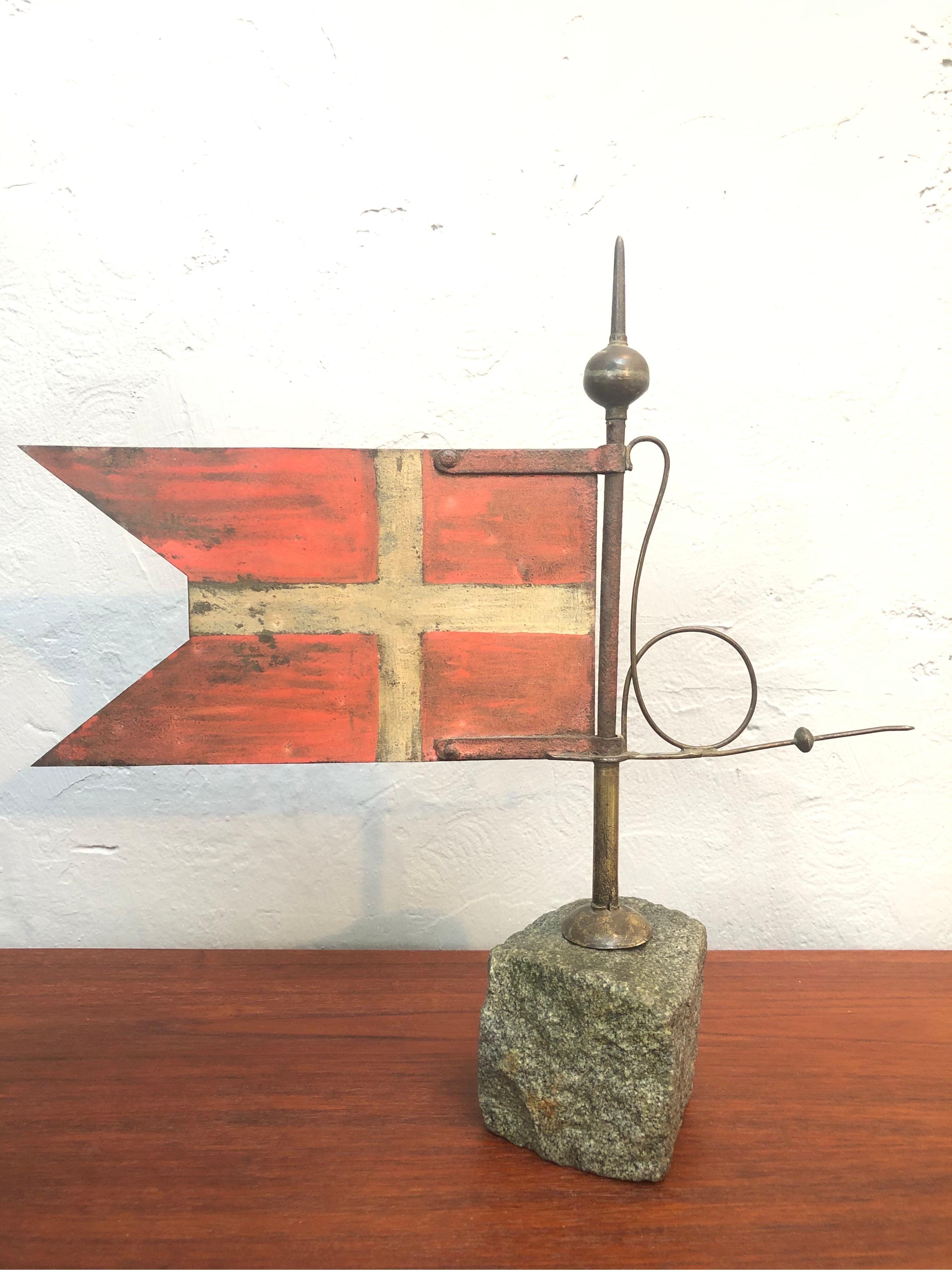 A very decorative antique Danish weather vane in the form of a Danish Flag otherwise known as Dannebrog. 
Made from copper with a lovely patina to the surface. 
Mounted on to a granite set.
Dated around the mid 1800s.
A lovely decorative piece.