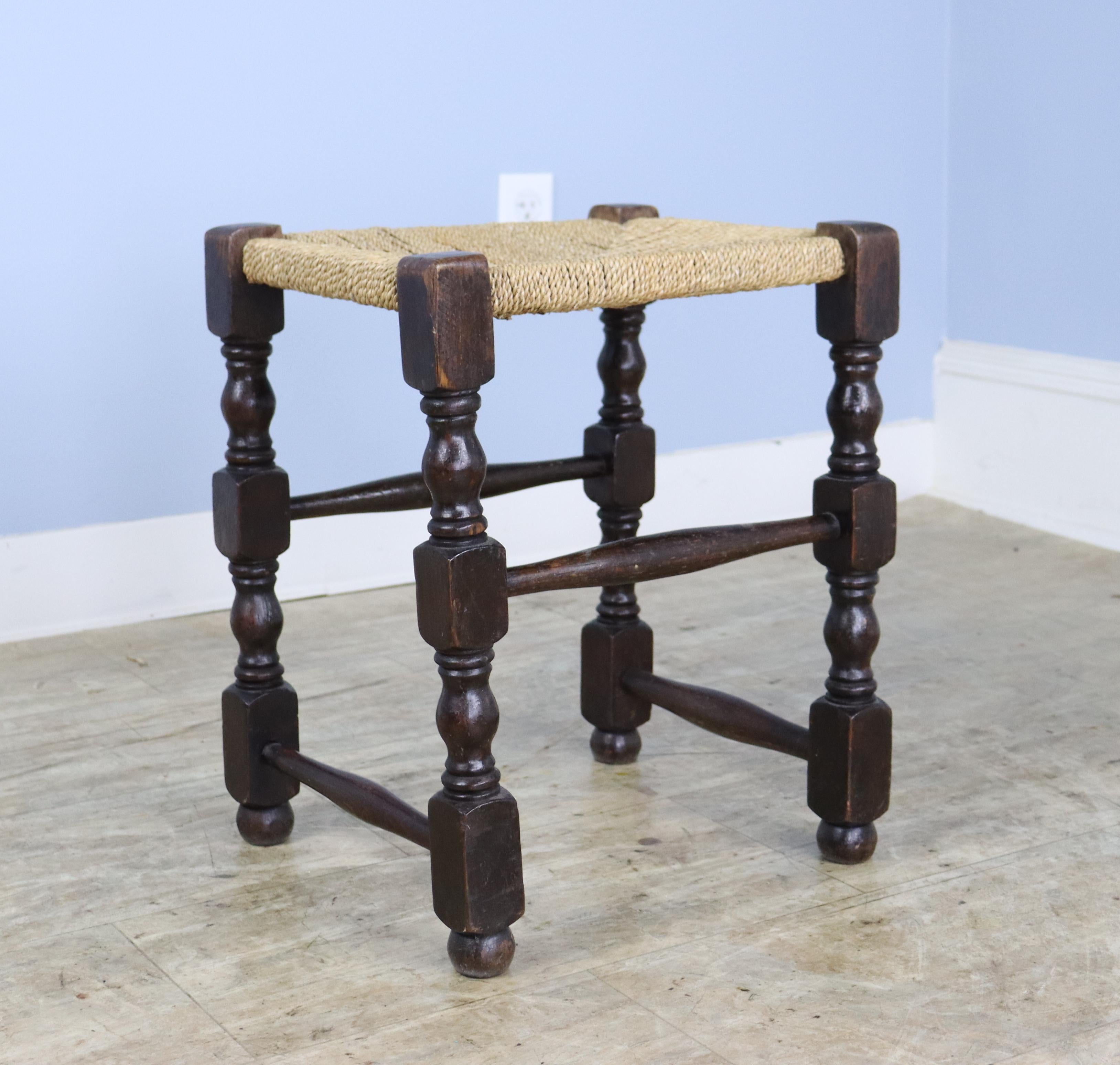 A dark oak version of the traditional English string stool complete with elegant patterned woven seat. Small enough to tuck away for extra seating, but so pretty it should be on display! Sturdy enough to use as a chair, pulled up to a desk or