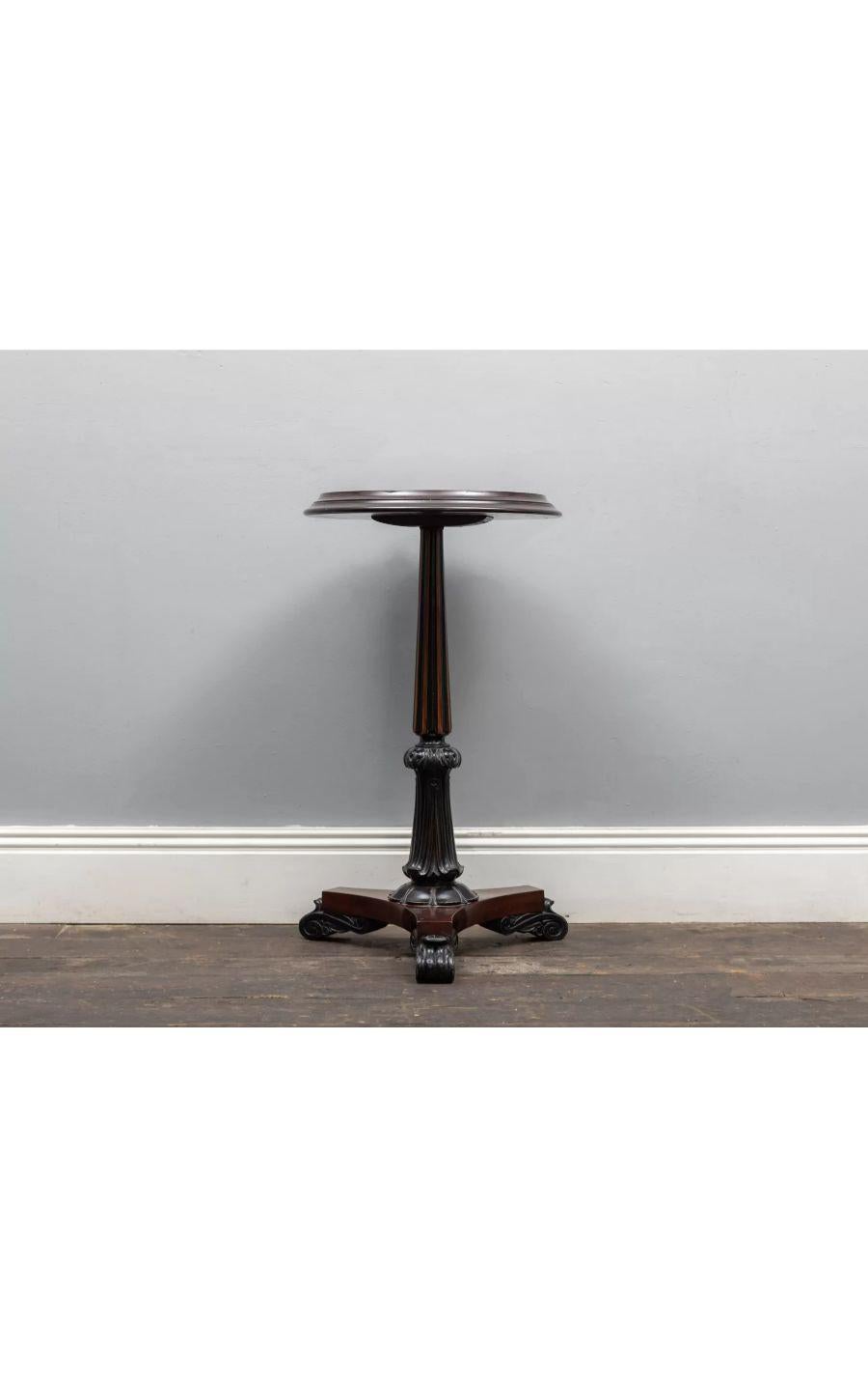 An antique mahogany occasional table with specimen marble and micro mosaic top.

The partially ebonized mahogany base comprises of a fluted and gadrooned stem on a tri-form plinth base with raised acanthus-leaf feet.

The inset circular top has