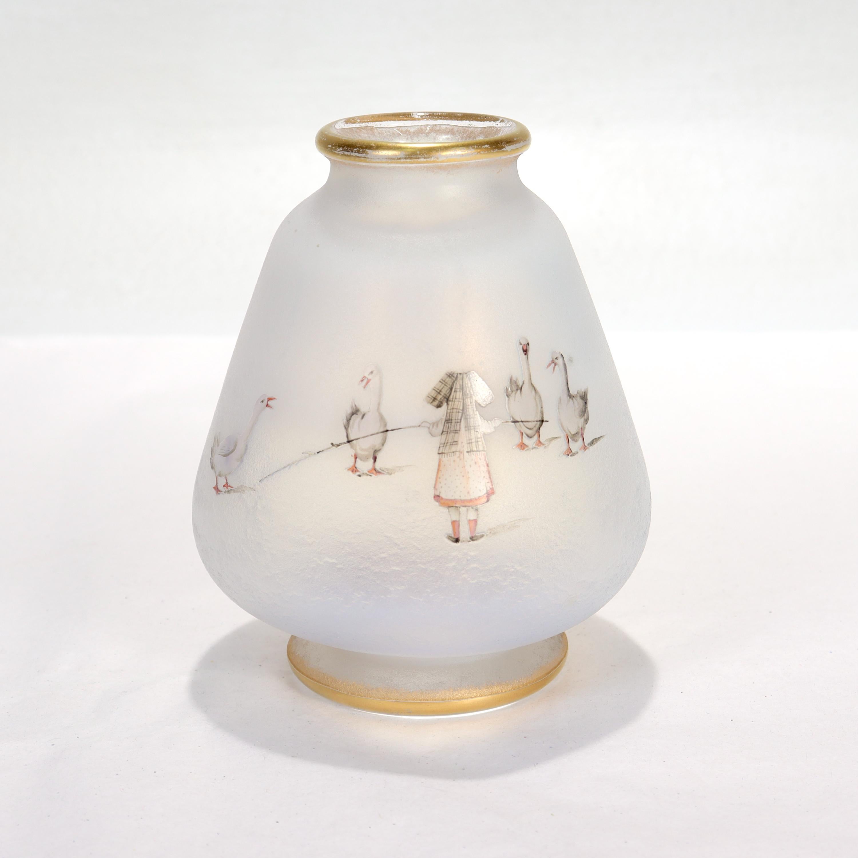 A fine French art glass vace.

By Daum Nancy.

In opalescent white glass with acid etched and grey & pink enamel decoration of a young girl with geese.

Entitled 'La Petit Gardause d'oies'. 

With an etched signature and the cross of