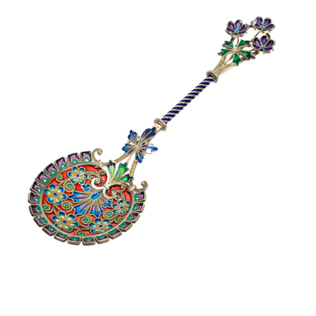 A fine antique plique a jour spoon.

By David Andersen.

In gold-washed sterling silver.

With a plique-a-jour bowl, twist wire handle, and finial. 

Having a lovely red, blue, green, yellow and purple enamel, and recurring motifs of a 5-pointed