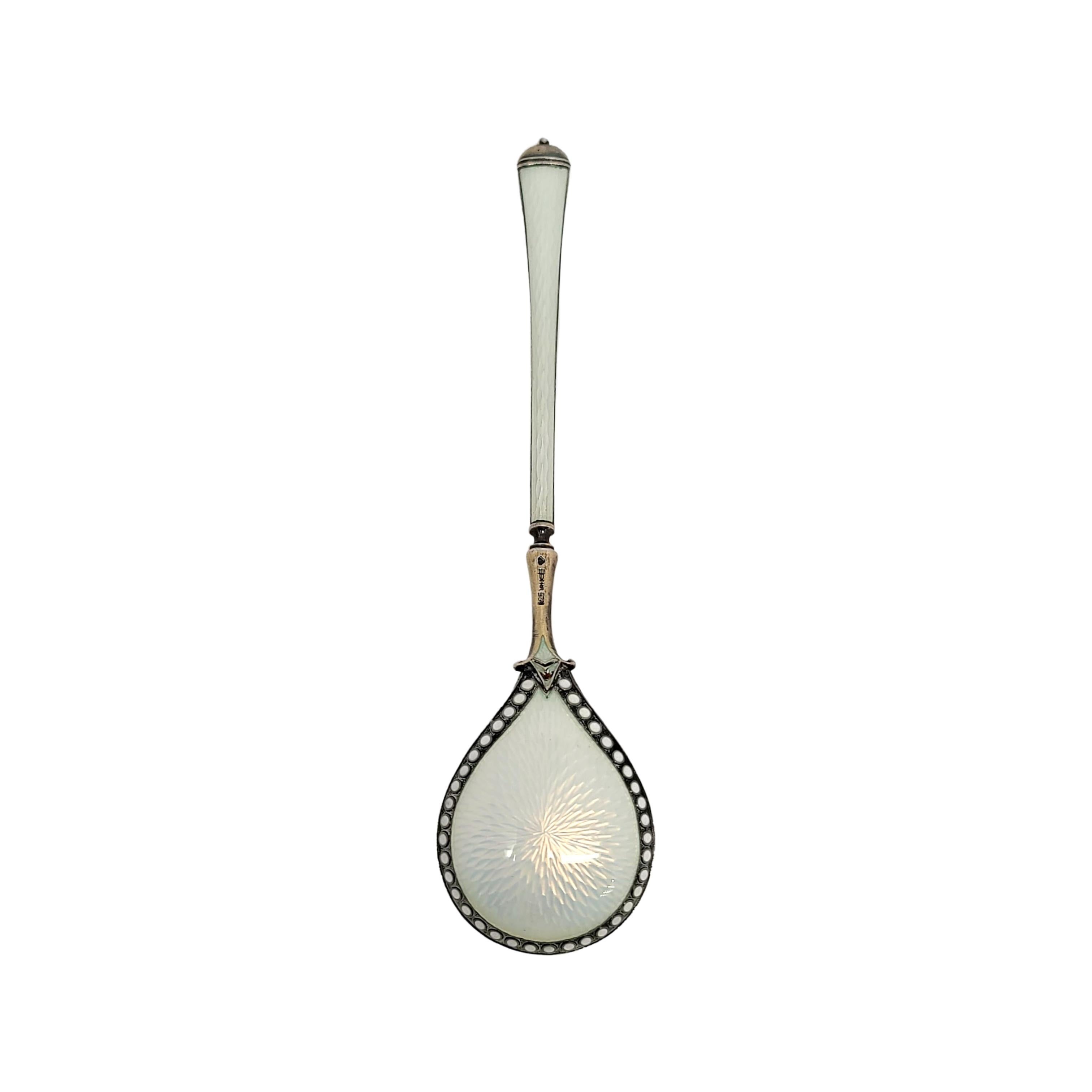 Vintage sterling silver and enamel spoon, by David Andersen Denmark.

Beautifully enameled spoon in white enamel. The back of the bowl is enameled and edged with white beads of enamel all around the bowl. Both sides of the handles are