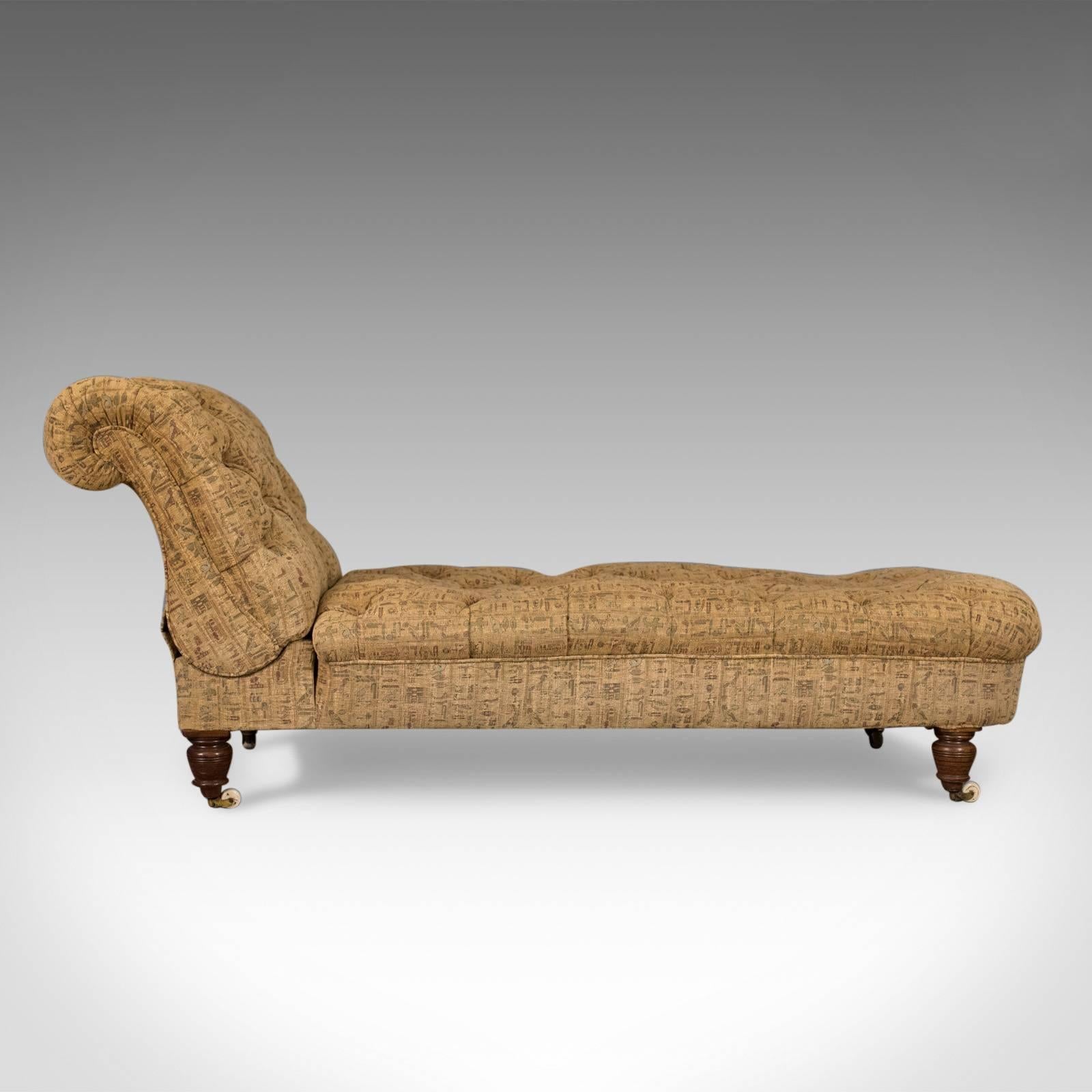 This is an antique daybed, a reclining chaise longue from the late Victorian period at the end of the 19th century, circa 1900.

Comfortable daybed with built in reclining backrest
Raised on squat turned, mahogany legs and ceramic