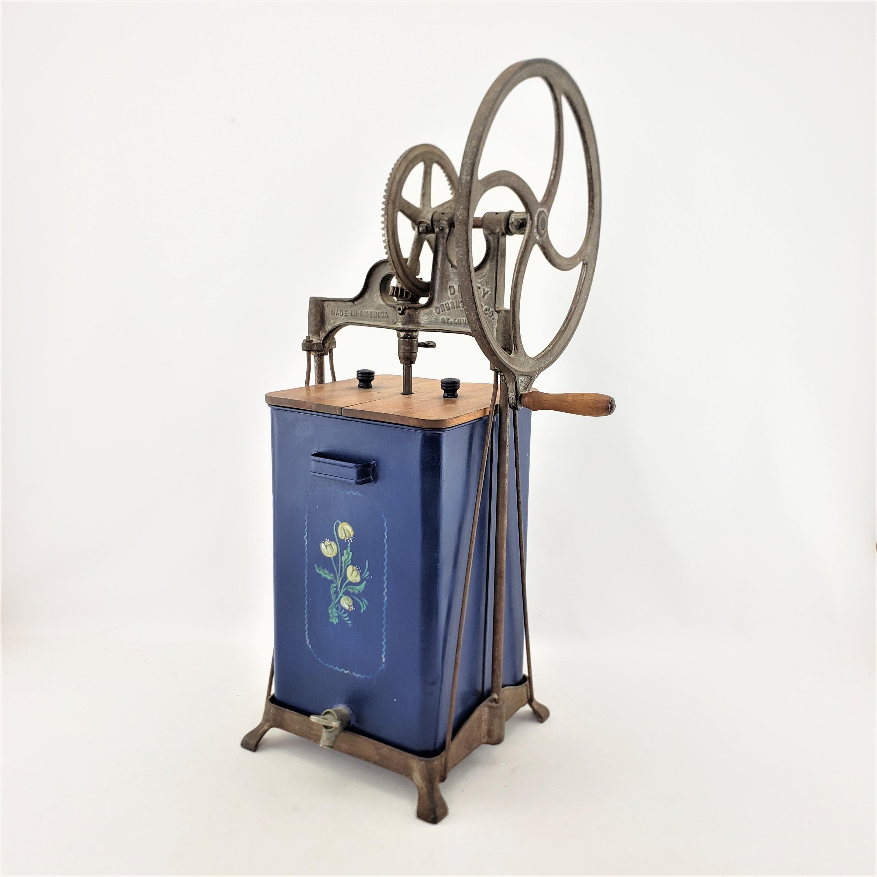 This antique commercial churn or mixer was made by the Dazey Manufacturing Company of St. Louis in approximately 1920 in a period Art Deco style. The frame and gear mechanism of the churn were made with cast metal and the container is made of steel.