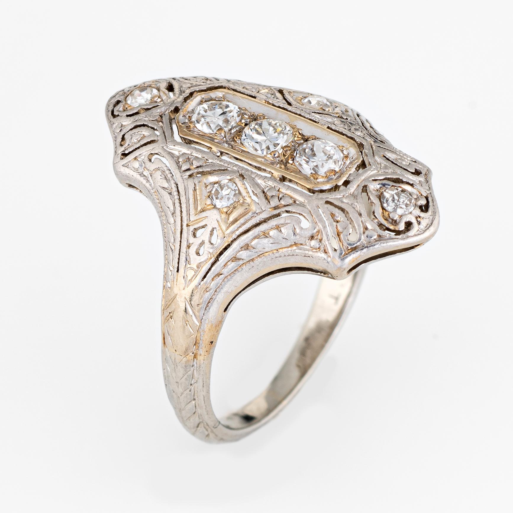 Finely detailed vintage Art Deco era ring (circa 1920s to 1930s) crafted in 18 karat white gold and platinum. 

Three centrally mounted estimated 0.10 carat old European cut diamonds and four estimated 0.01 carat single cut diamonds are set into the