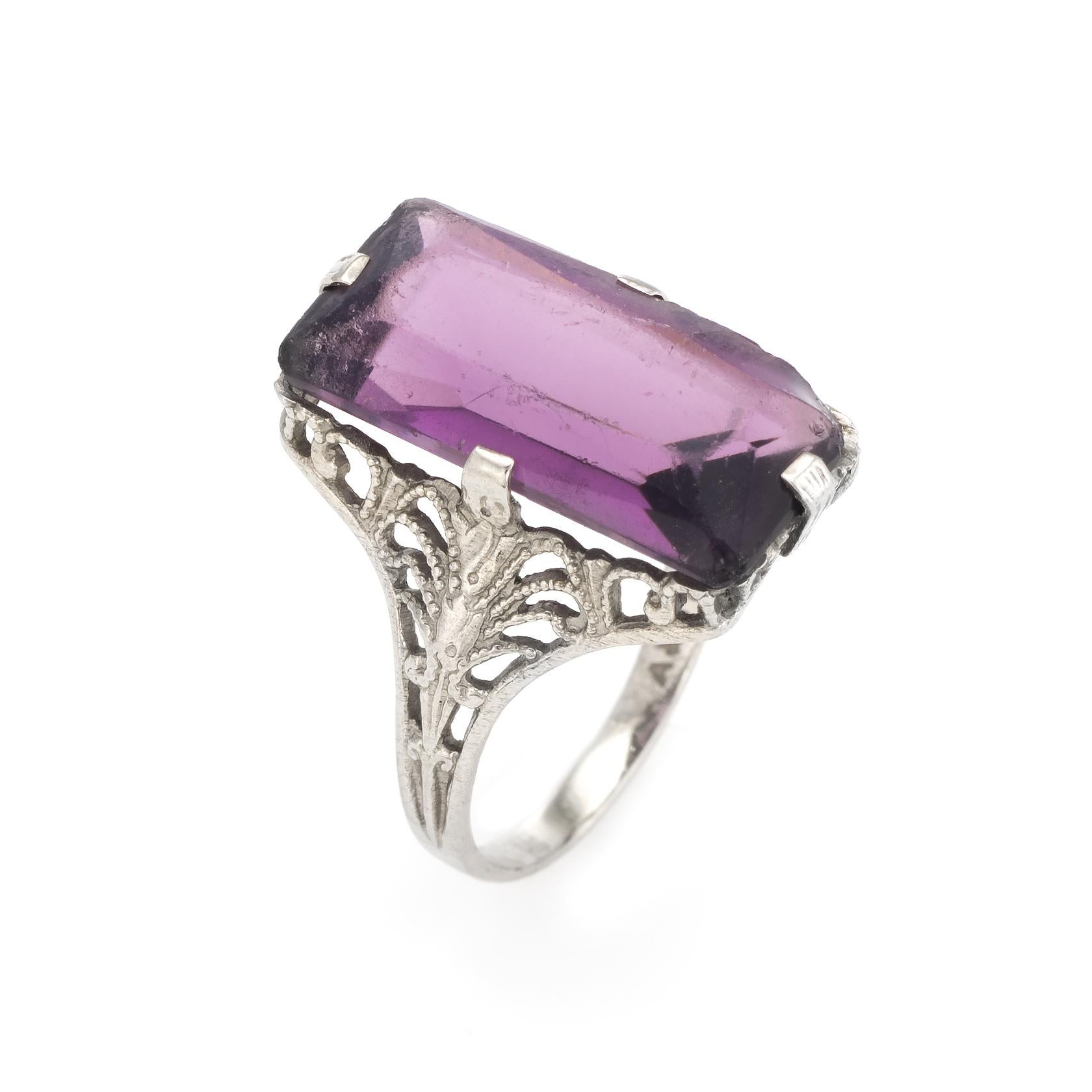 Finely detailed vintage Art Deco era cocktail ring (circa 1920s to 1930s), crafted in 10 karat white gold. 

Centrally mounted amethyst measures 15.75mm x 8mm (estimated at 5.50 carats). The amethyst is in good condition with wear evident (light