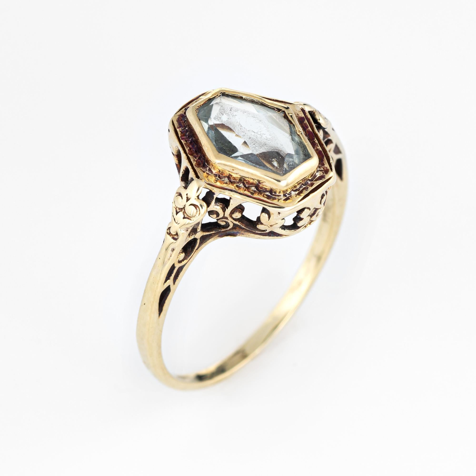 Stylish vintage Art Deco era ring (circa 1920s to 1930s) crafted in 14 karat yellow gold. 

Fancy cut aquamarine measures 9mm x 6mm (estimated at 1 carat). The aquamarine shows light surface abrasions from wear (visible under a 10x loupe). 

The