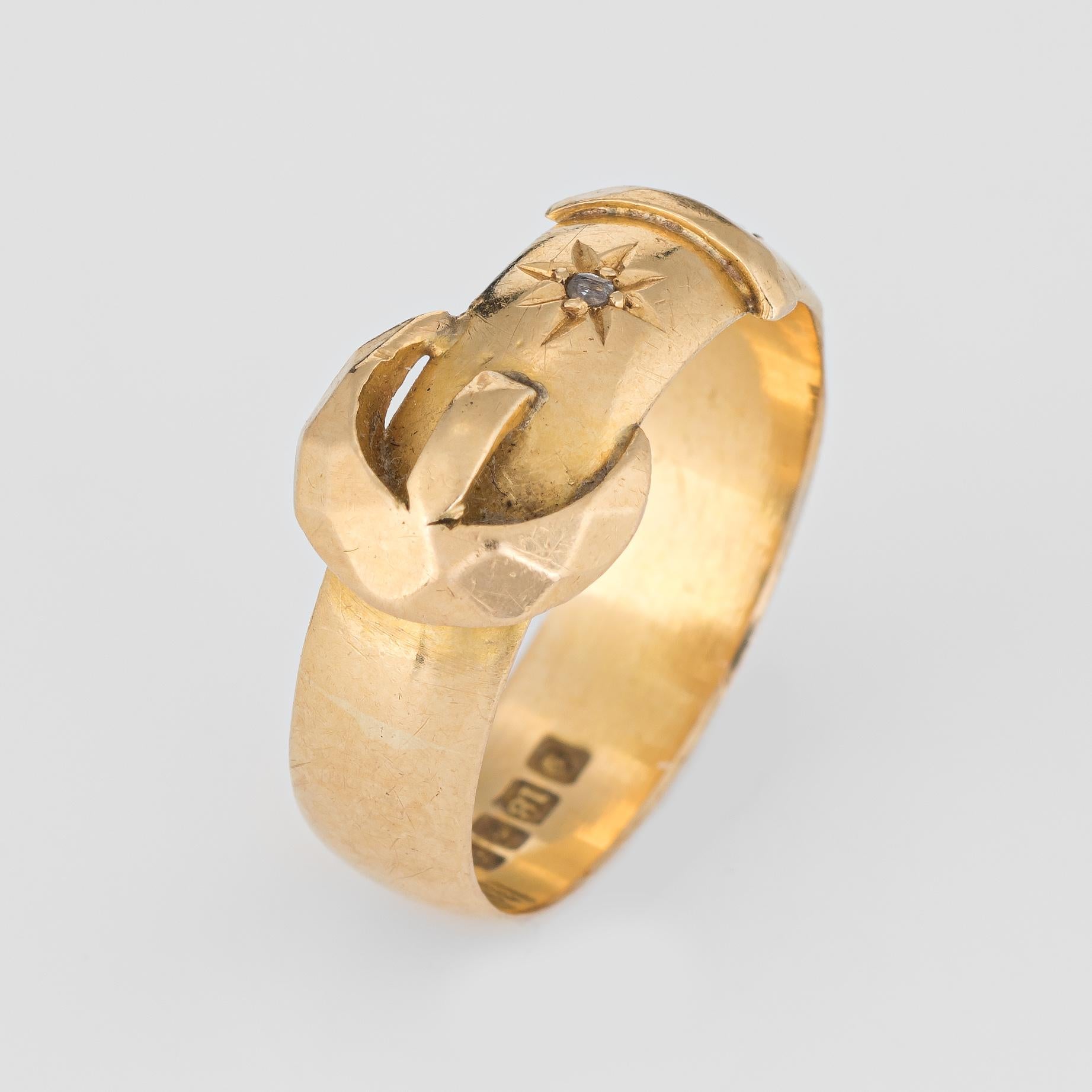 Finely detailed antique buckle ring (circa 1918), crafted in 18 karat yellow gold. 

Two estimated 0.01 carat old rose cut diamond chips are set into the mount. The total diamond weight is estimated at 0.02 carats (estimated at I-J color and I2