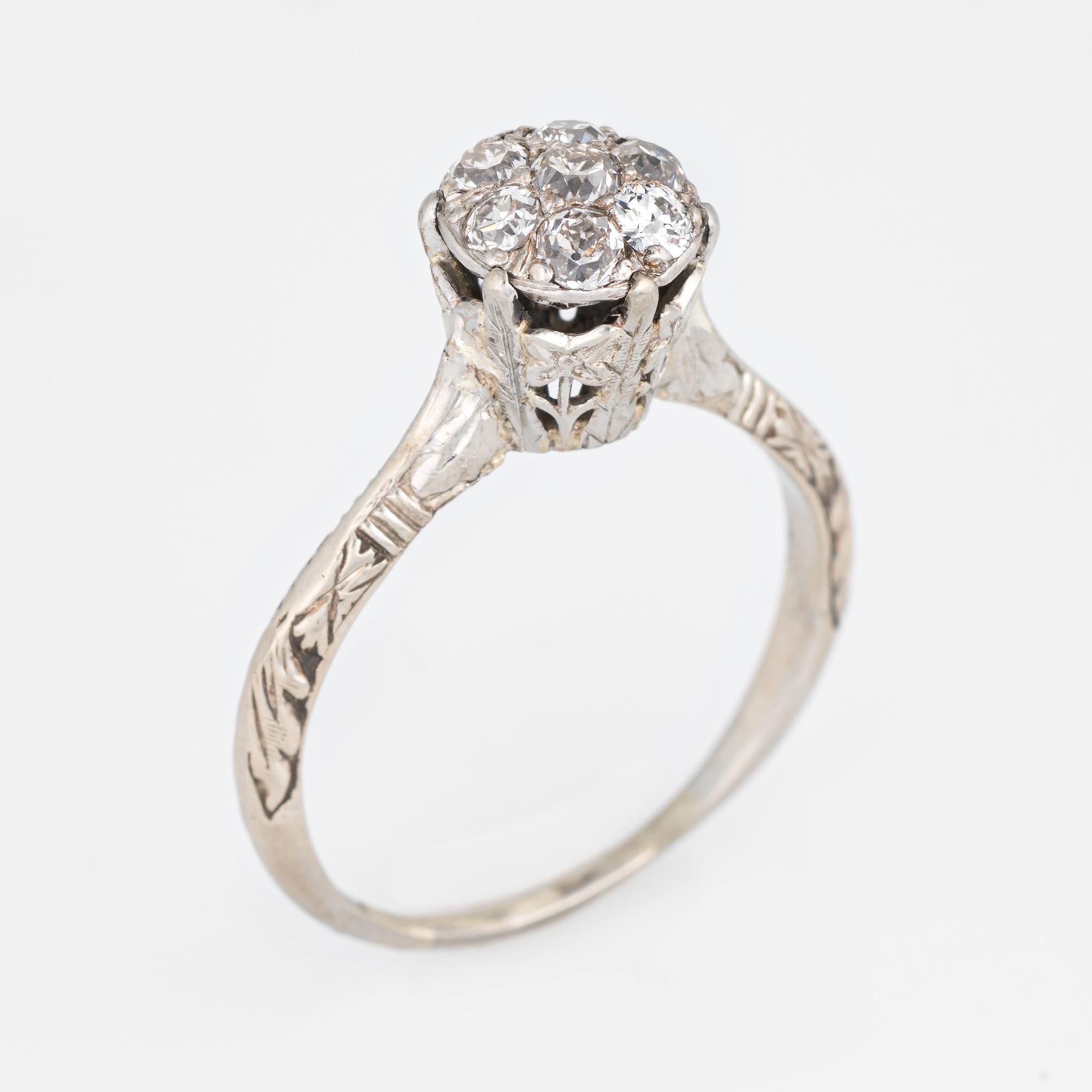 Elegant vintage Art Deco era ring (circa 1920s to 1930s) crafted in 18 karat white gold. 

Centrally mounted old European cut diamonds are estimated at 0.05 carats each (7 total). The total diamond weight is estimated at 0.35 carats (estimated at