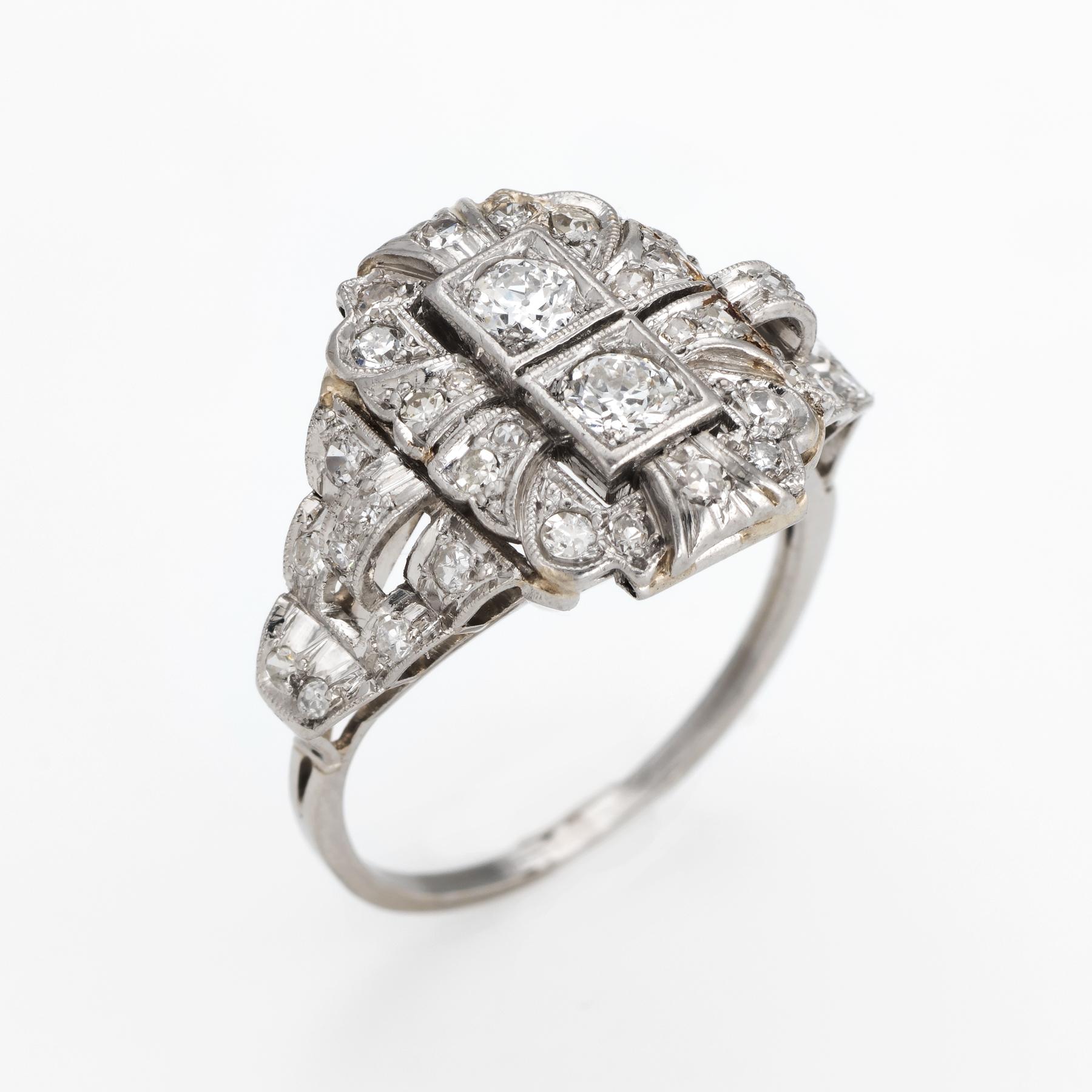 Elegant & finely detailed Art Deco era ring (circa 1920s to 1930s), crafted in 900 platinum. 

Two centrally mounted estimated 0.20 carat (each) Old European cut diamonds are accented with an estimated 0.34 carats of single cut diamonds. The total