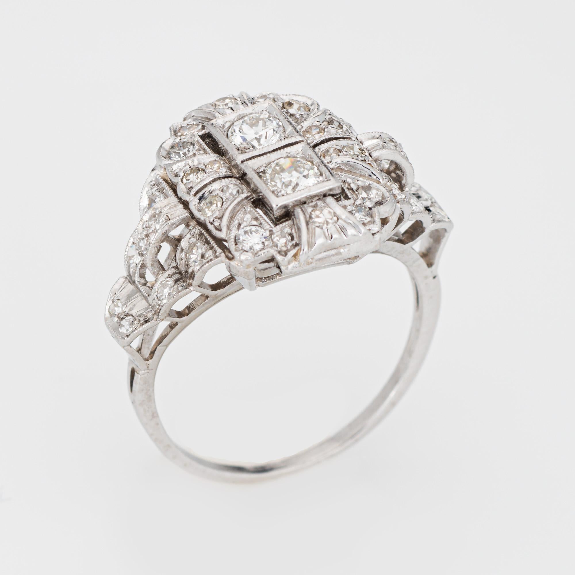 Elegant & finely detailed Art Deco era ring (circa 1920s to 1930s), crafted in 900 platinum. 

Two centrally mounted estimated 0.20 carat (each) Old European cut diamonds are accented with an estimated 0.34 carats of single cut diamonds. The total