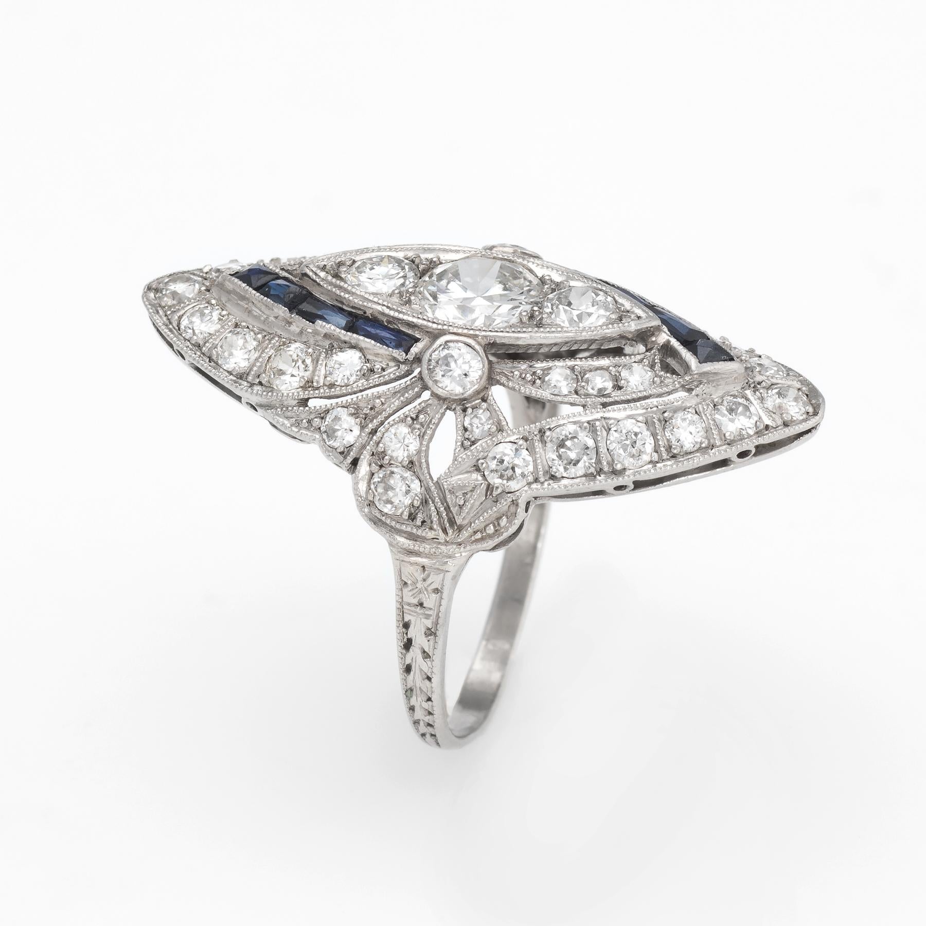 Elegant & finely detailed Art Deco era ring (circa 1920s to 1930s), crafted in 900 platinum. 

Centrally mounted estimated 0.60 carat old European cut diamond is flanked a further 36 diamonds ranging in size from 0.01 to 0.10 carat. The total