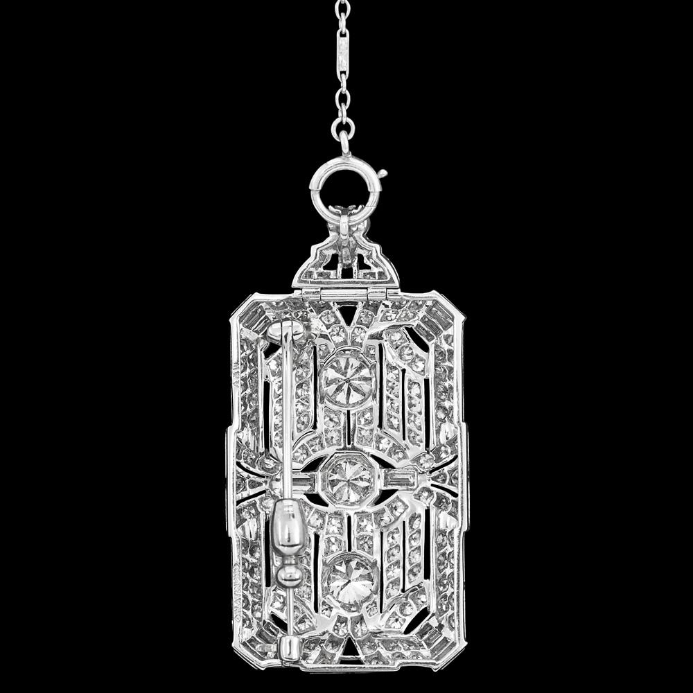 Alluring jewelry of the Art Deco era this antique European diamond pendant necklace is intricately crafted in platinum.

A rectangle shield pendant is a marvel of design, featuring a mesmerizing array of baguettes and European cut diamonds. The