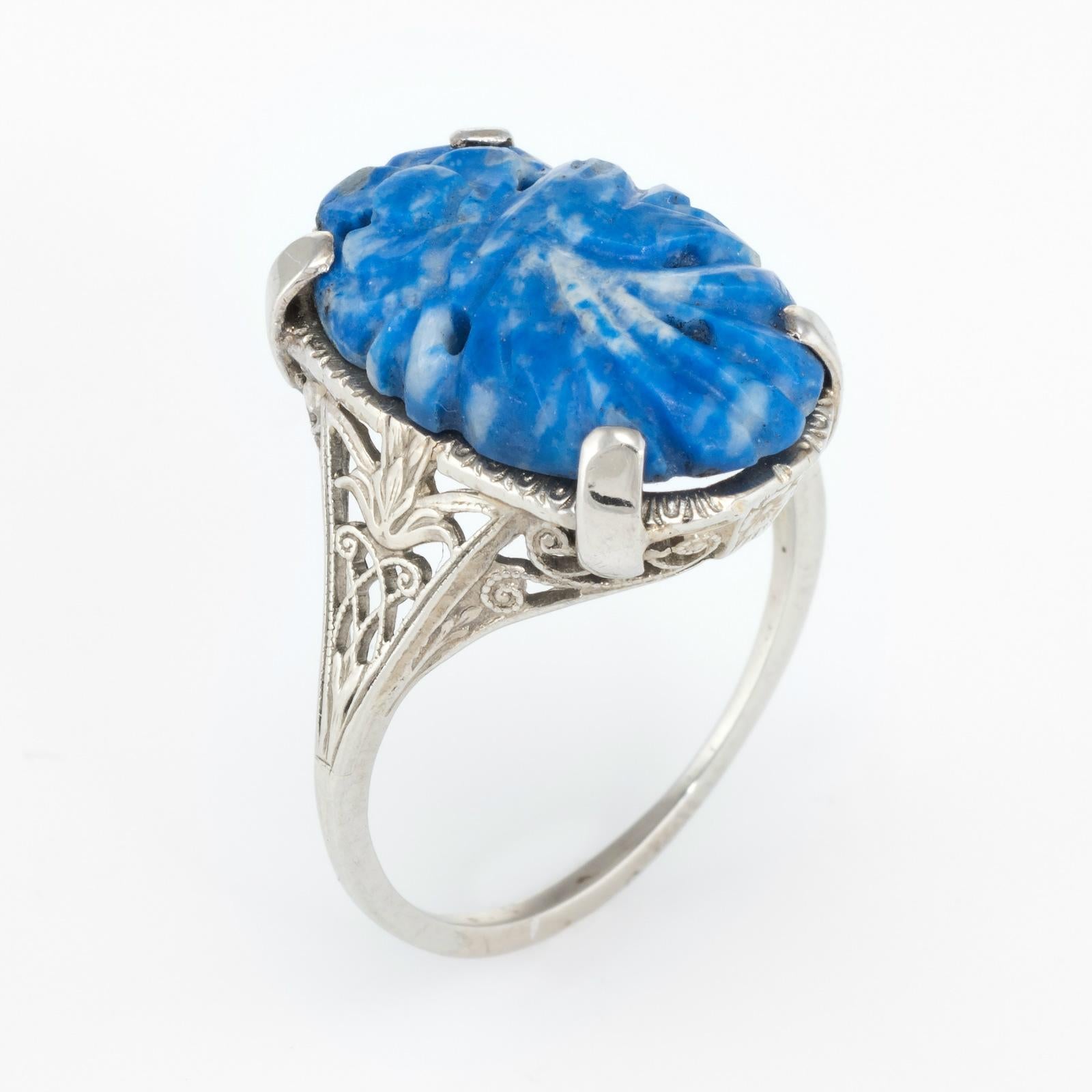 Elegant Art Deco era ring (circa 1920s to 1930s), crafted in 14 karat white gold. 

Sodalite is carved in a floral motif and measures 18.5mm x 12.75mm. The sodalite is in excellent condition and free of cracks or chips.  

The ring is in excellent