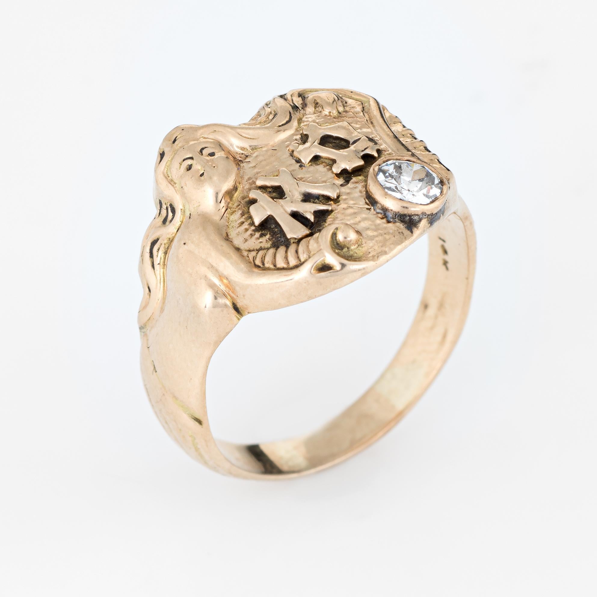 Elegant vintage Art Deco era ring (circa 1920s to 1930s), crafted in 14 karat yellow gold. 

One old mine cut diamond is estimated at 0.20 carats (estimated at H-I color and SI2 clarity).

The ring epitomizes vintage charm with the mermaid design.