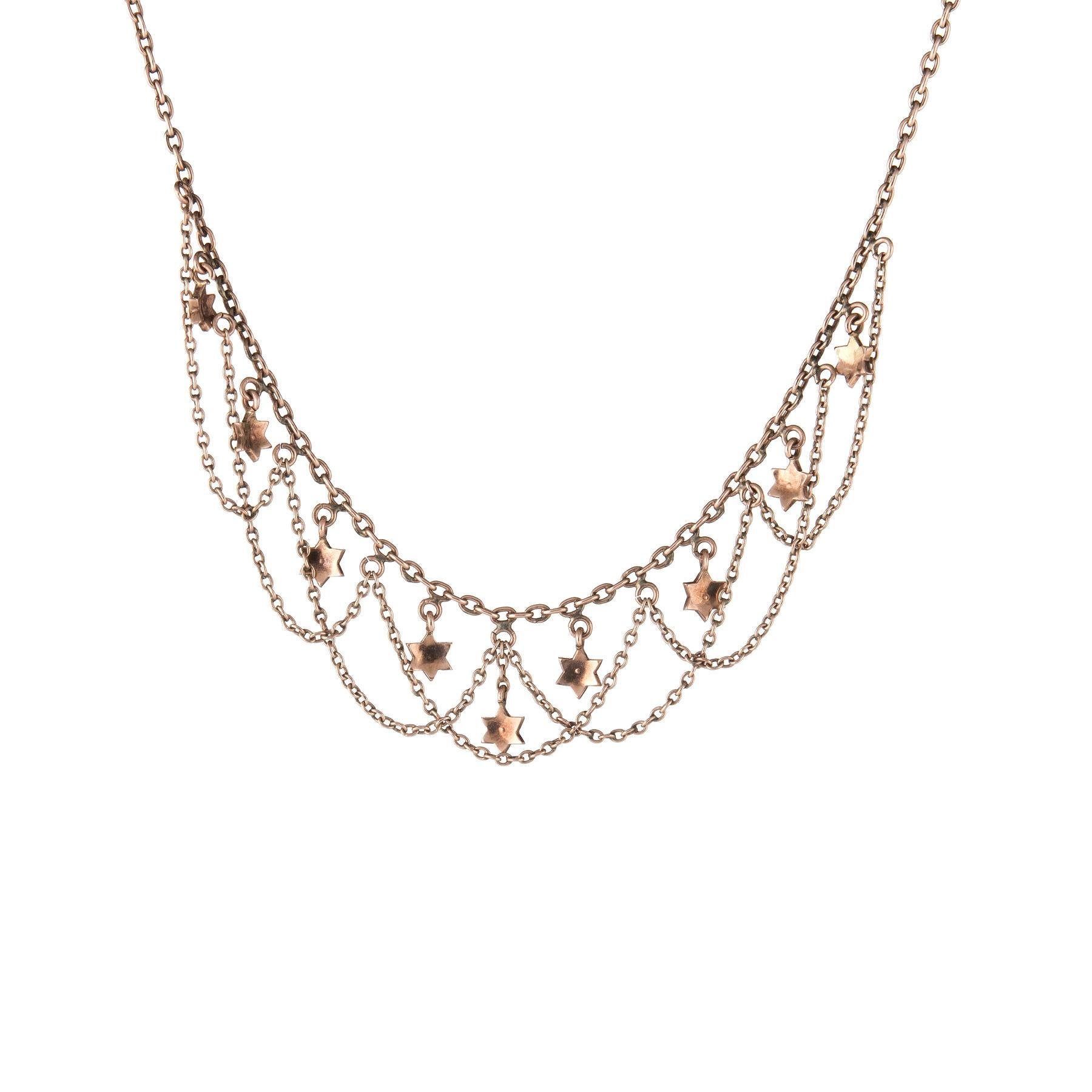 Elegant and finely detailed Art Deco era necklace (circa 1920s to 1930s), crafted in 10 karat rose gold.  

9 seed pearls are each set into the stars (approx. 1mm). 

The necklace measures 15 inches in length and sits nicely at the nape of the