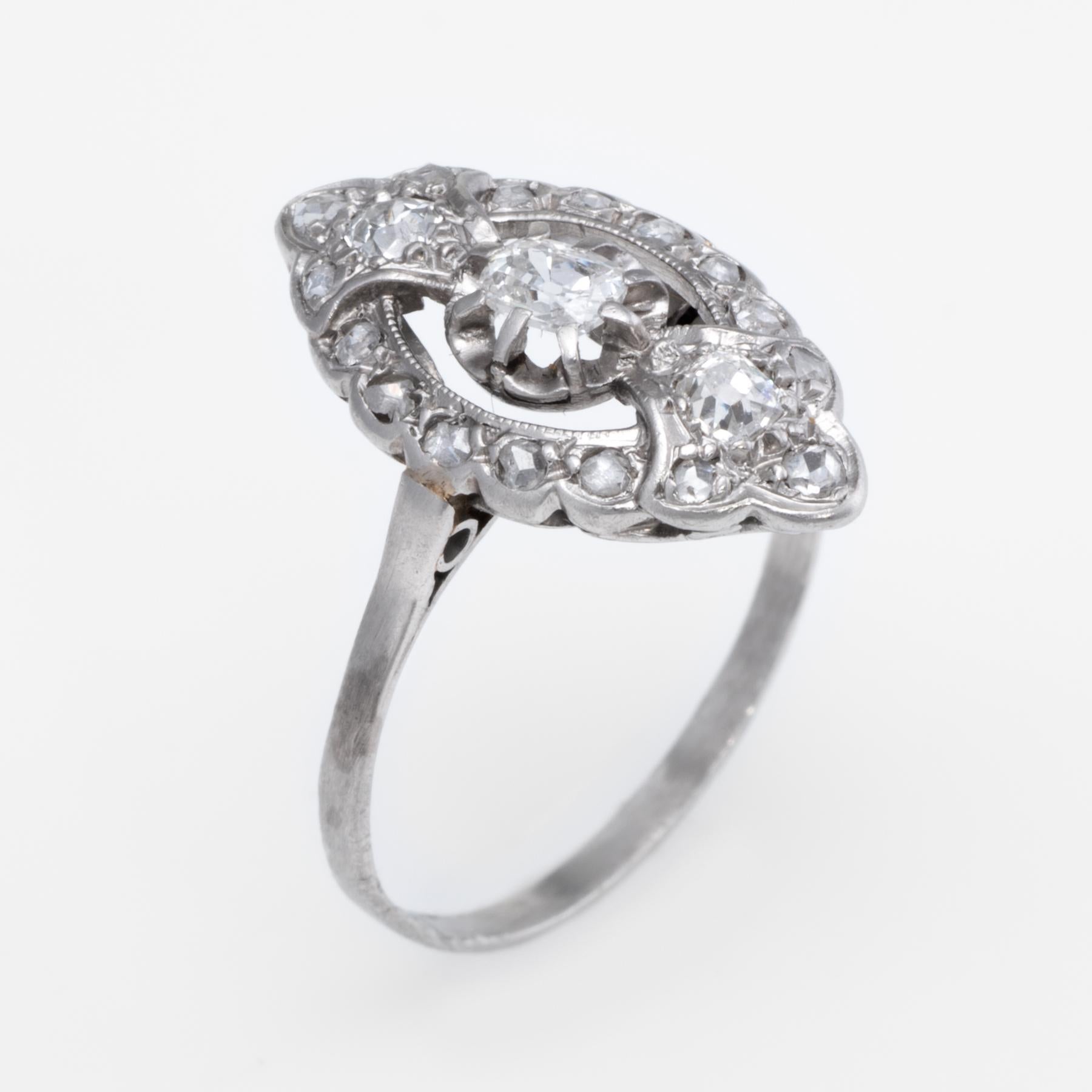 Finely detailed vintage Art Deco era ring (circa 1920s to 1930s), crafted in 900 platinum. 

Centrally mounted estimated 0.25 carat old cushion cut diamond is accented with two estimated 0.08 carat cushion cut diamonds (each) and a further 16