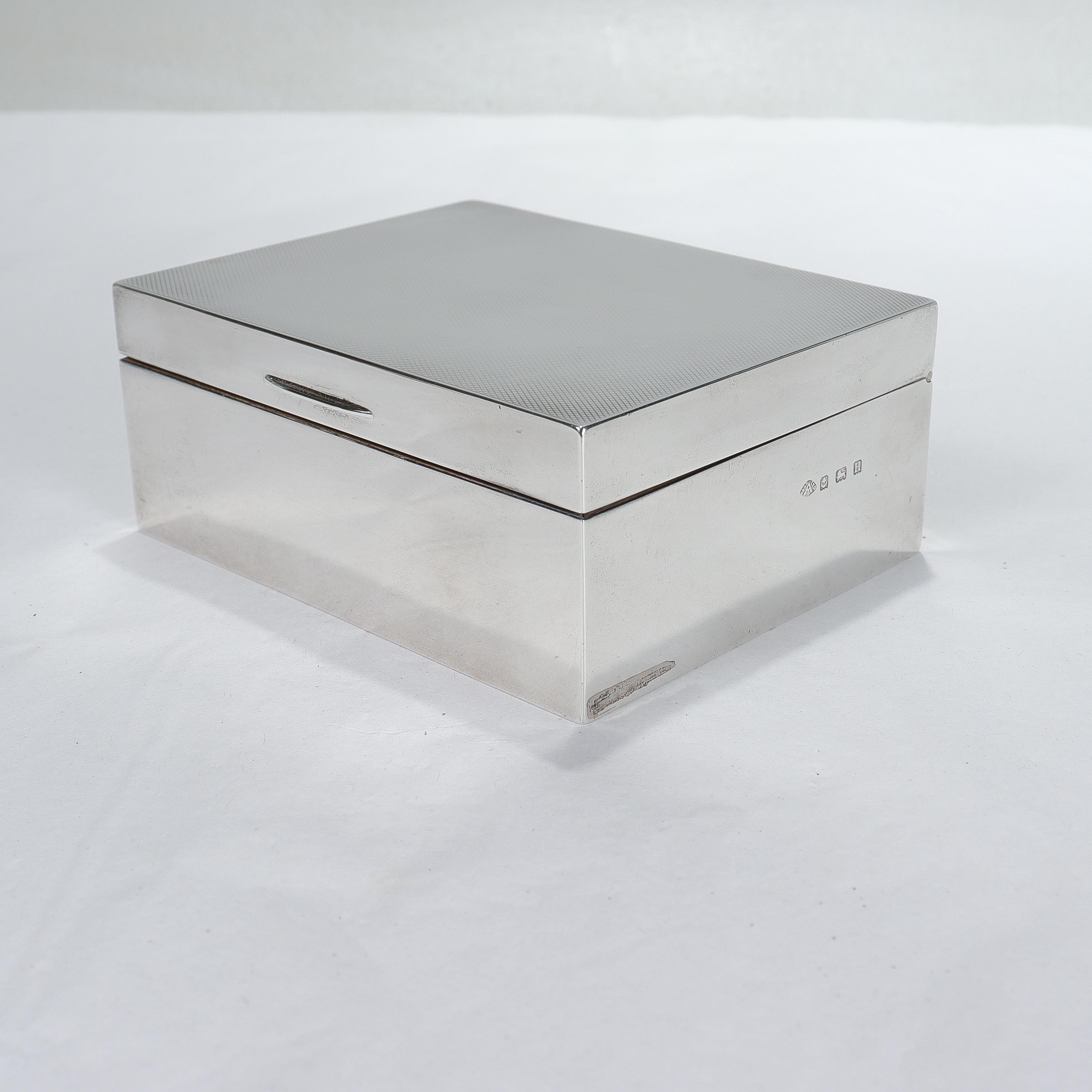 A fine English Art Deco sterling silver presentation dresser or vanity box.

By Adie Brothers of Birmingham.

In sterling silver.

With a shark skin finish to the lid and a dedication to the interior that reads:

