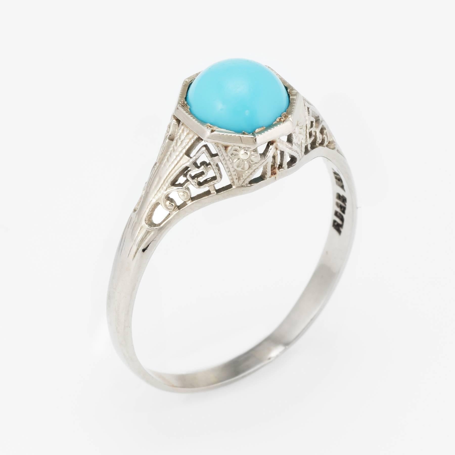 Finely detailed vintage Art Deco era ring (circa 1920s to 1930s), crafted in 14 karat white gold. 

Cabochon cut turquoise measures 6.6mm (estimated at 1.50). The turquoise is in excellent condition and free of cracks or chips.   

Lacy filigree