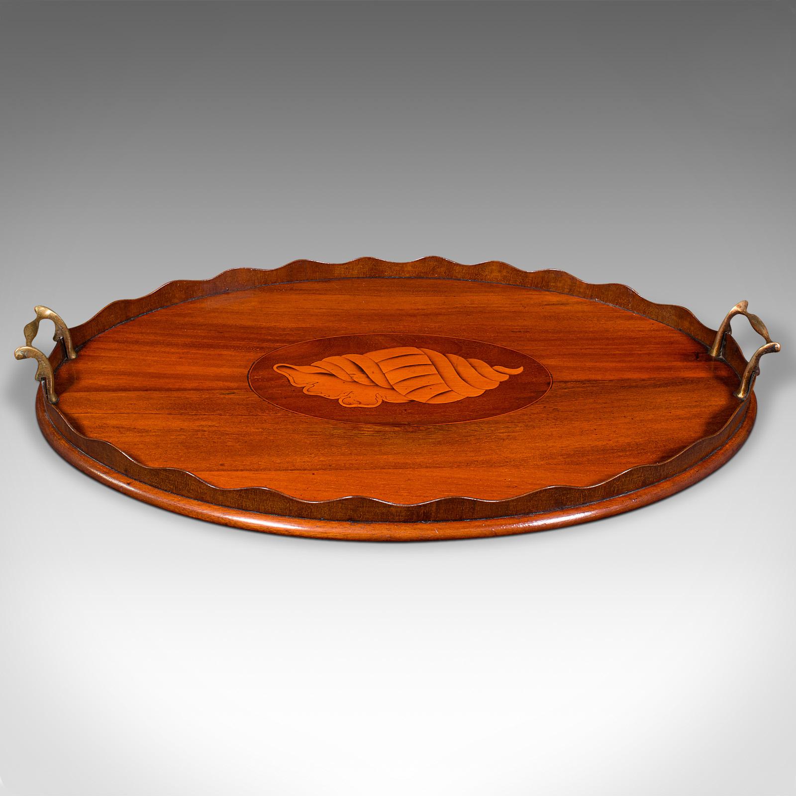 This is an antique decorative afternoon tea tray. An English, mahogany and boxwood serving platter, dating to the Regency period, circa 1820.

Delightful tray for serving guests with Regency period elegance
Displaying a desirable aged patina and in