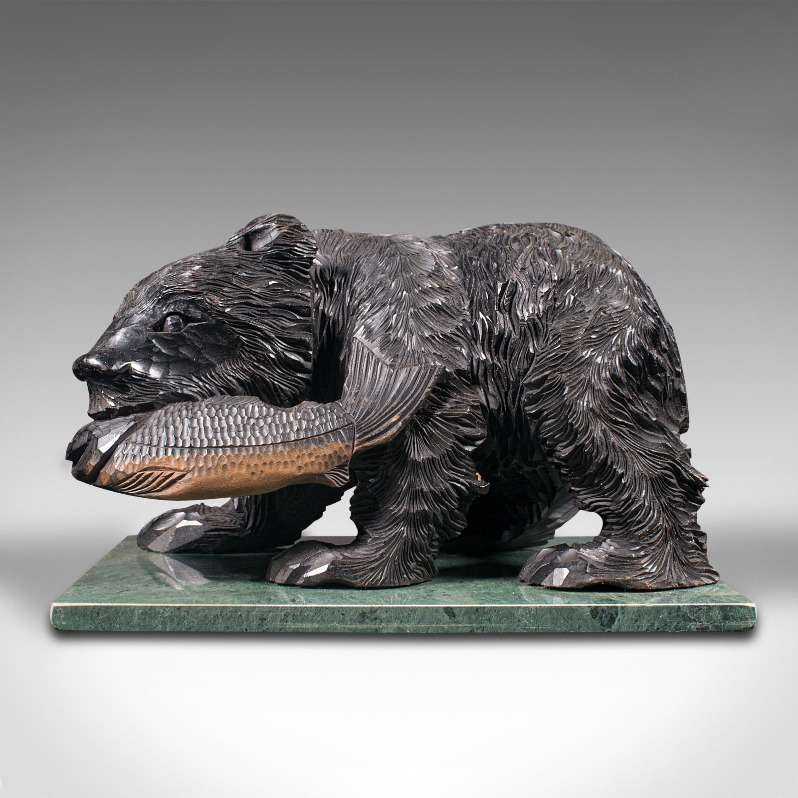 This is an antique decorative bear figure. A German, carved fruitwood natural study in the Black Forest taste, dating to the late Victorian period, circa 1900.

Enthusiastically carved and fascinating study of the large riverside
