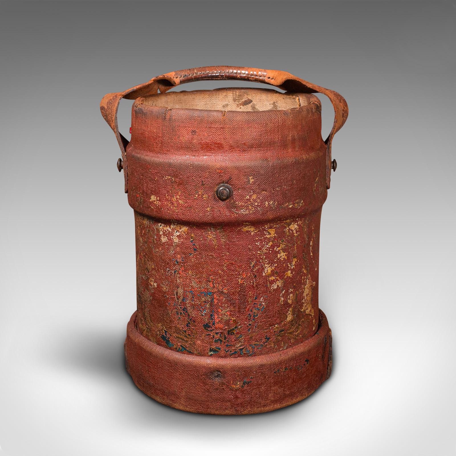 This is an antique decorative bucket. An English, waxed canvas and leather log or storage bin, dating to the Edwardian period, circa 1910.

Presents a fascinating, pleasingly weathered appeal
Displays a desirable aged patina throughout
Canvas