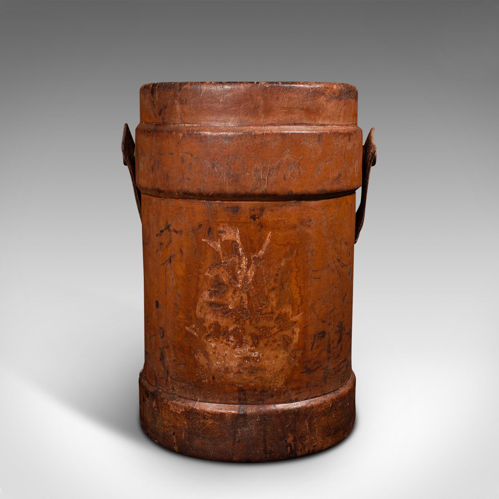 This is an antique decorative bucket. An English, leather garden basket, stick stand or storage bin, dating to the Victorian period, circa 1900.

Wonderfully patinated and rich in colour
Displays a desirable aged patina throughout
Leather tanned