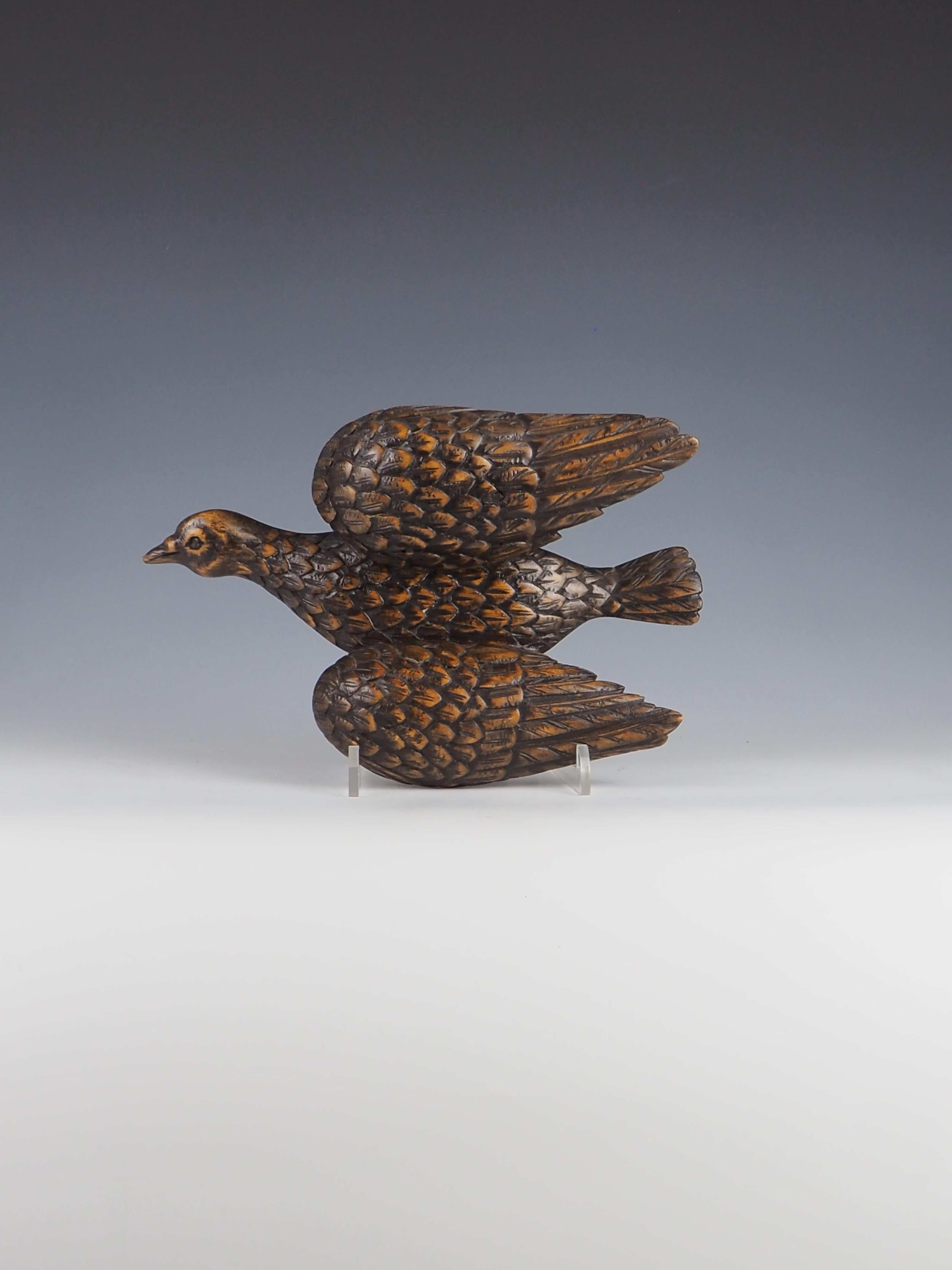 Exquisite antique decorative carved bird is a stunning piece that showcases intricate craftsmanship and attention to detail.

The bird’s design features delicate carvings that highlight its natural form, making it a captivating addition to any home
