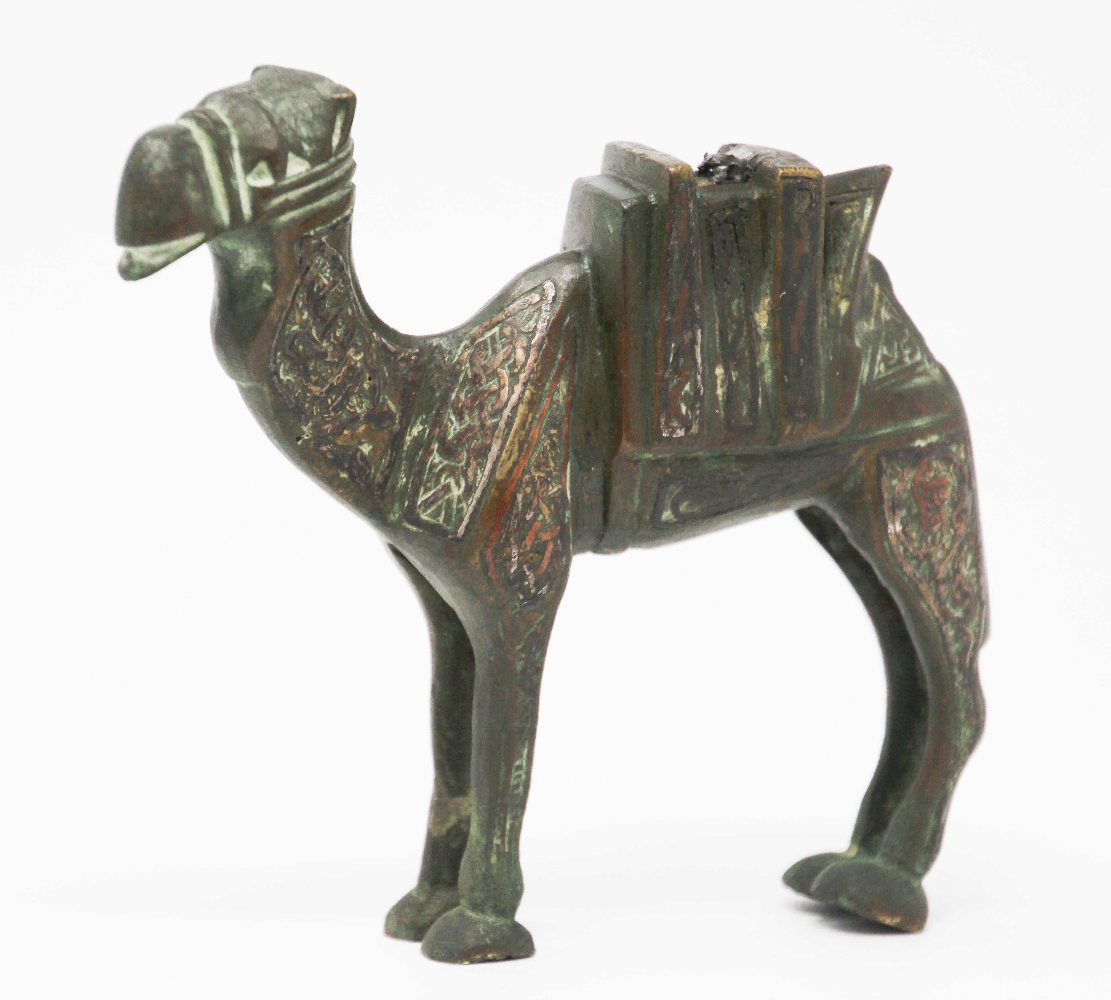This is an antique metal cast brass overlaid with copper decoration sculpture of a camel, circa 1920.
Brass handcrafted sculpture in Mameluke revival style, Islamic inlay metal artwork.
Very decorative unusual overlaid with copper, silver and black