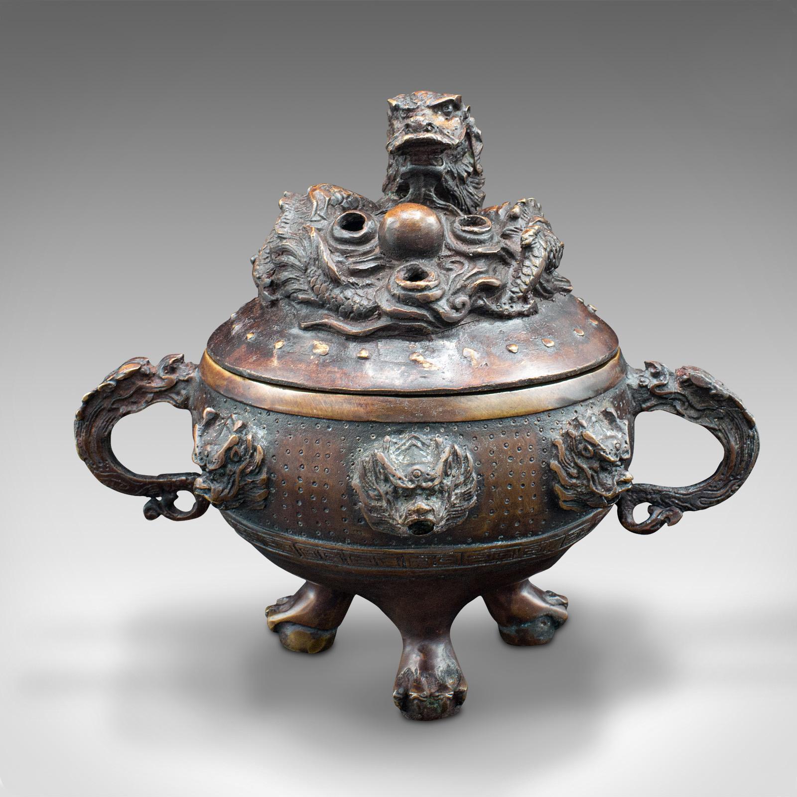 This is an antique decorative censer. A Chinese, bronze incense burner with dragon detail, dating to the late Victorian period, circa 1900.

Strikingly patinated and formed incense burner, with prominent dragon motif.
Displays a desirable aged