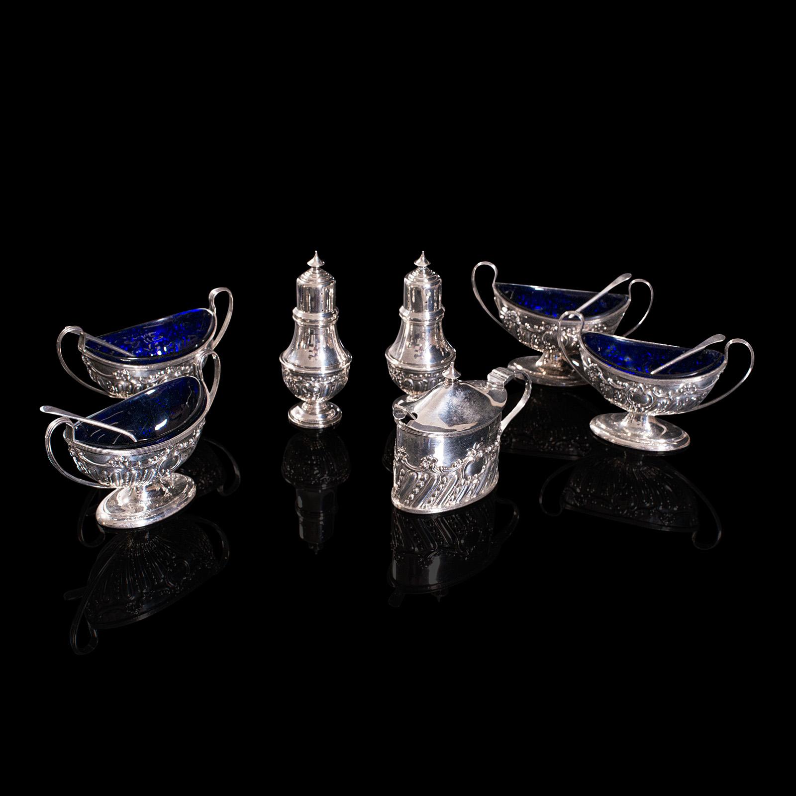 This is an antique decorative condiment set. An English, sterling silver boxed set by Henry Matthews of Birmingham, hallmarked in the Edwardian period, dated 1909.

A fine set, presented wonderfully within the original quality case
Displaying a