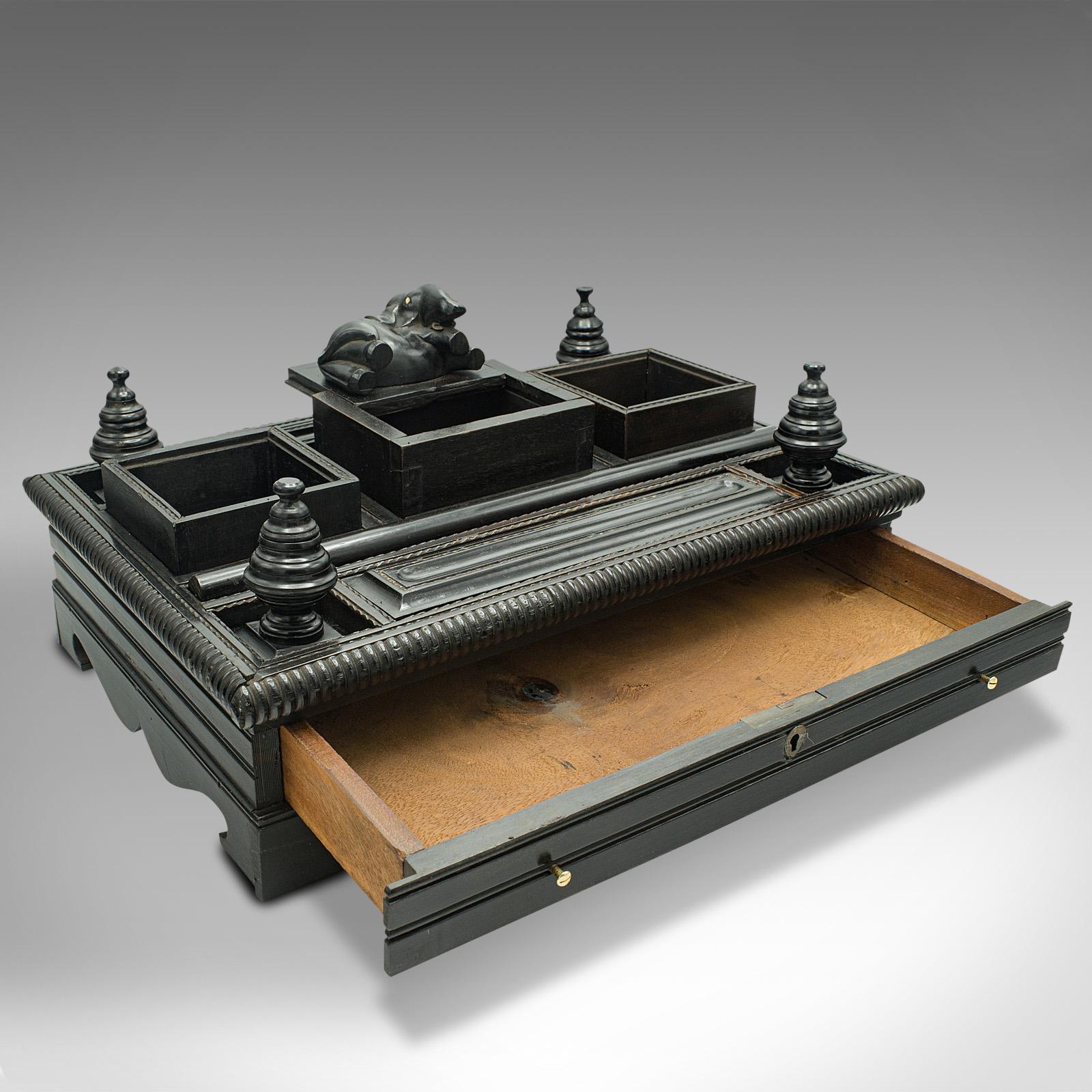 This is an antique decorative desk stand. An Indian, ebony Colonial writer's tidy, dating to the early Victorian period, circa 1850.

Striking dark tonality with eye-catching Colonial taste
Displays a desirable aged patina and in good