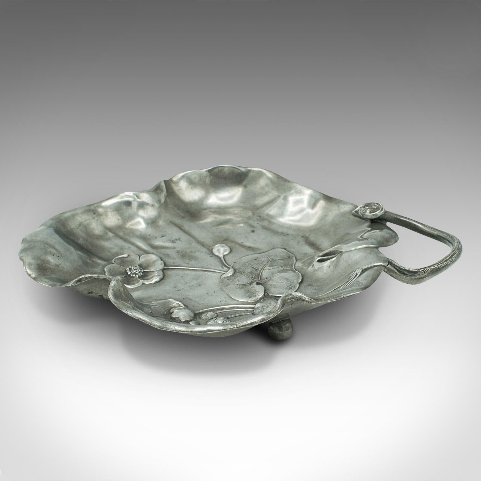 This is an antique decorative dish. A German, pewter bonbon tray in Art Nouveau taste, dating to the Edwardian period, circa 1910.

Delightful dogwood blossom decor adorns this charming dish
Displaying a desirable aged patina and in good