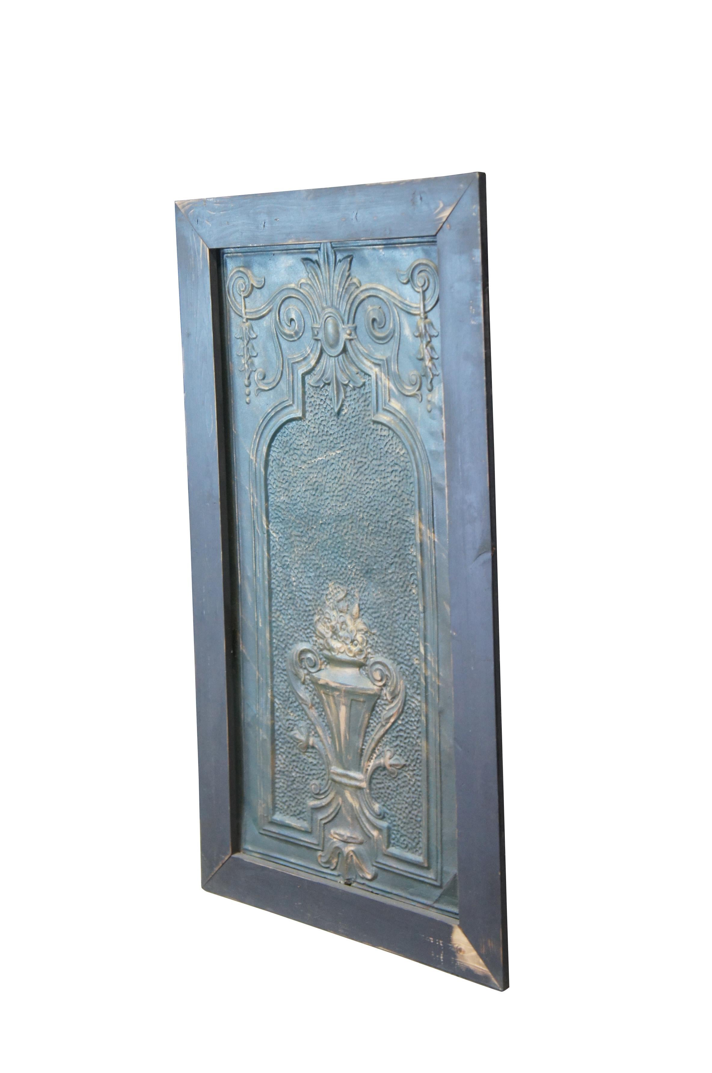 Vintage decorative embossed and hammered tin panel featuring a trophy urn with flowers, fleur de lis and acanthus accents.

Dimensions:
28