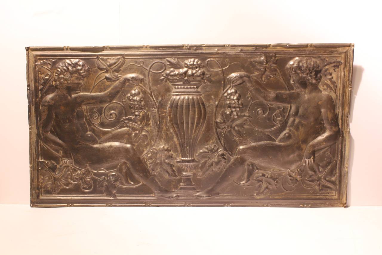 Antique American decorative figural tin wall panel.