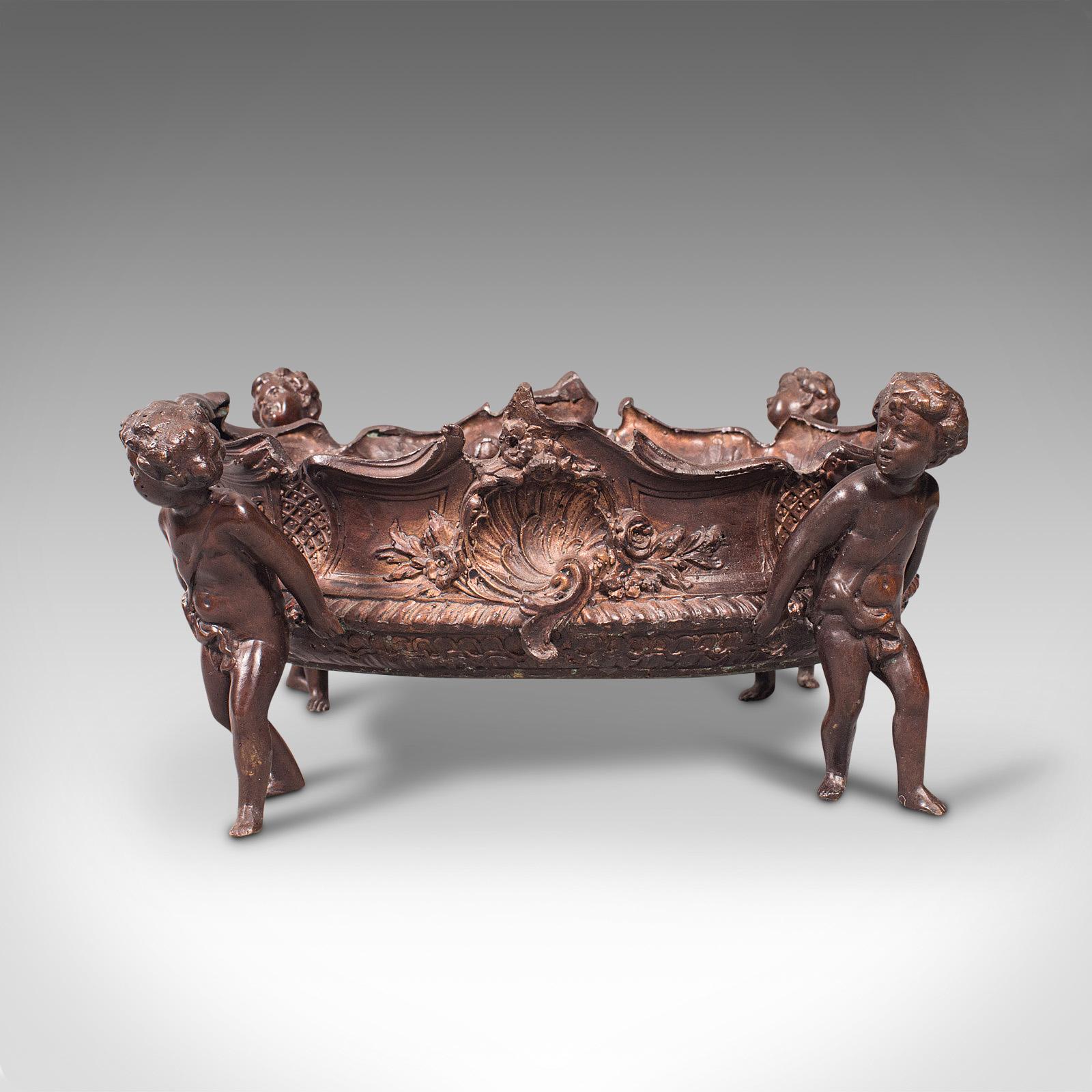 This is an antique decorative jardiniere. An Italian, bronze planter or fruit serving bowl with Putto legs, dating to the late Victorian period, circa 1900.

Delightful Italianate taste and cherubic interest
Displays a desirable aged patina and