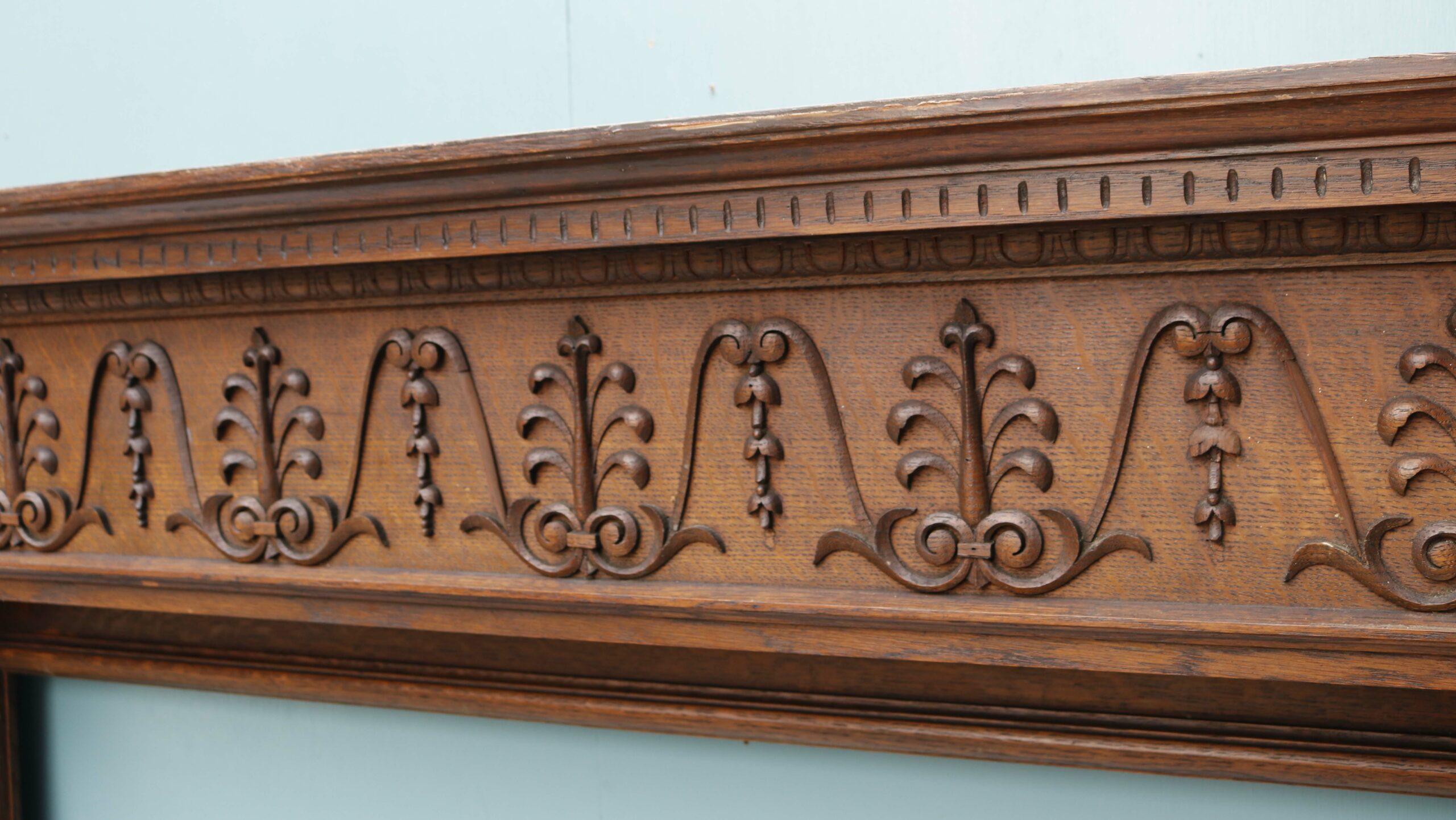Antique Decorative Oak Fireplace. Solid carved oak with charming bell flowers and anthemion along the frieze. Supported on a pair of beautiful fluted columns.

Opening height 107 cm (42.12 in)

Opening width 110 cm (43.30 in)

Across the foot blocks