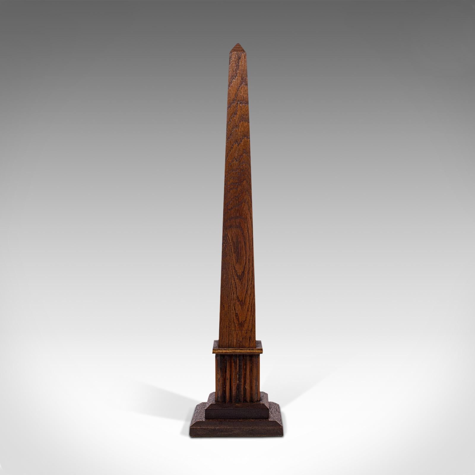 This is a tall antique decorative obelisk. An Italian, oak carved monolith or cenotaph, dating to the late 19th century, circa 1900.

Fascinating decorative piece from the days of the grand tour
Displaying a desirable aged patina and in good