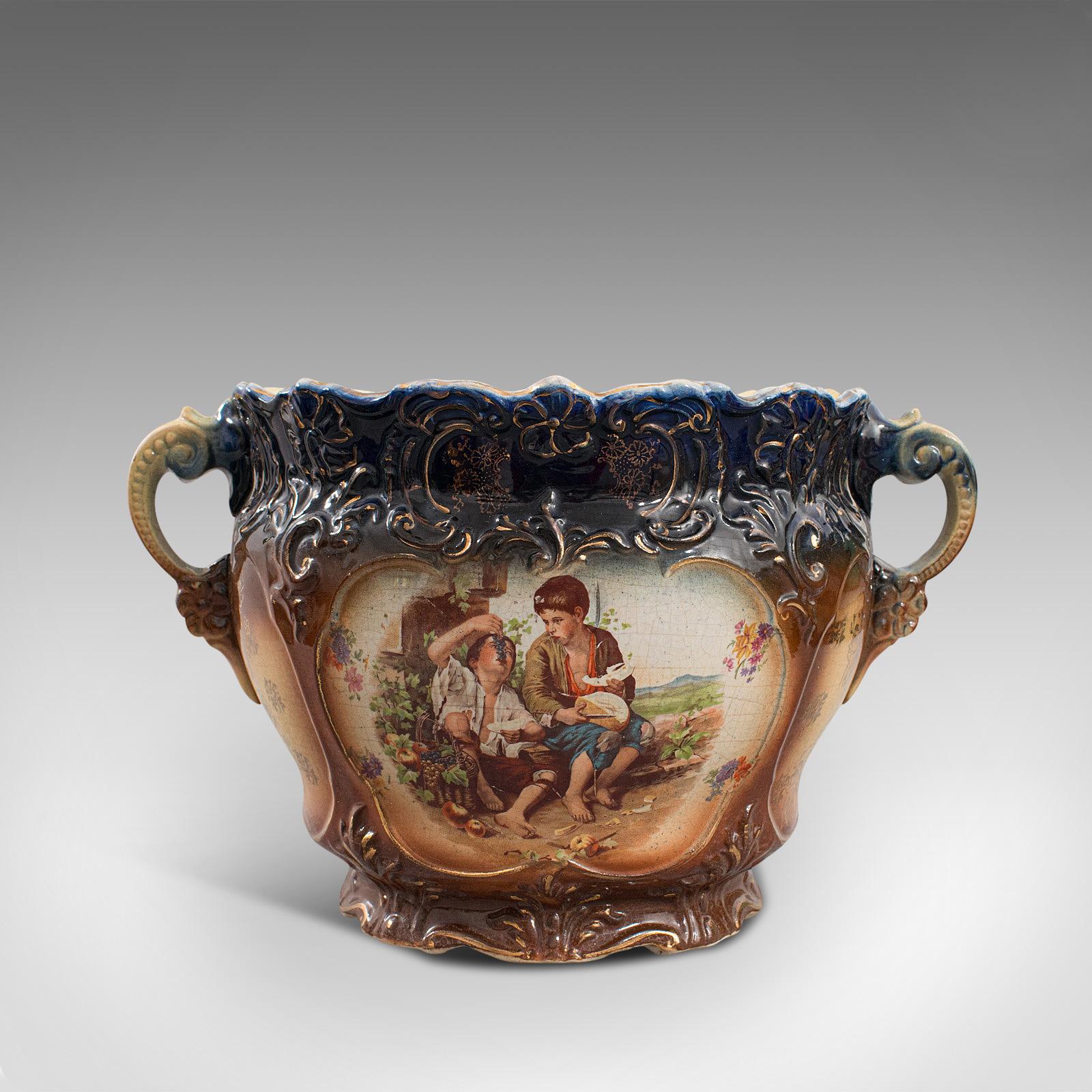 This is an ornate antique decorative planter. An English, ceramic jardiniere or bowl, dating to the Edwardian period, circa 1910.

Elaborate painted detail draws the eye
Displaying a desirable aged patina - characterful crazing beneath the
