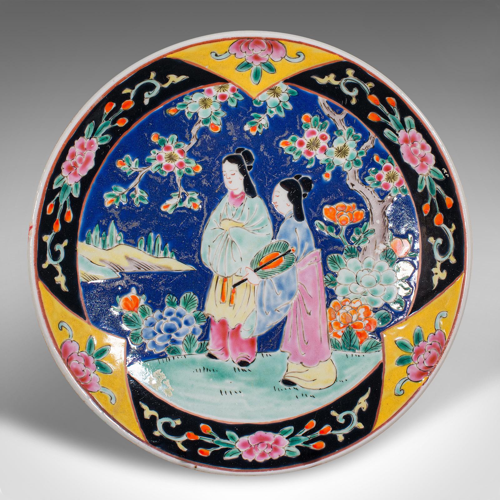 This is an antique decorative plate. A Chinese, ceramic display charger, dating to the late Victorian period, circa 1900.

Colourful Qing dynasty display plate, with appealing decor
Displays a desirable aged patina and in good order
Quality white