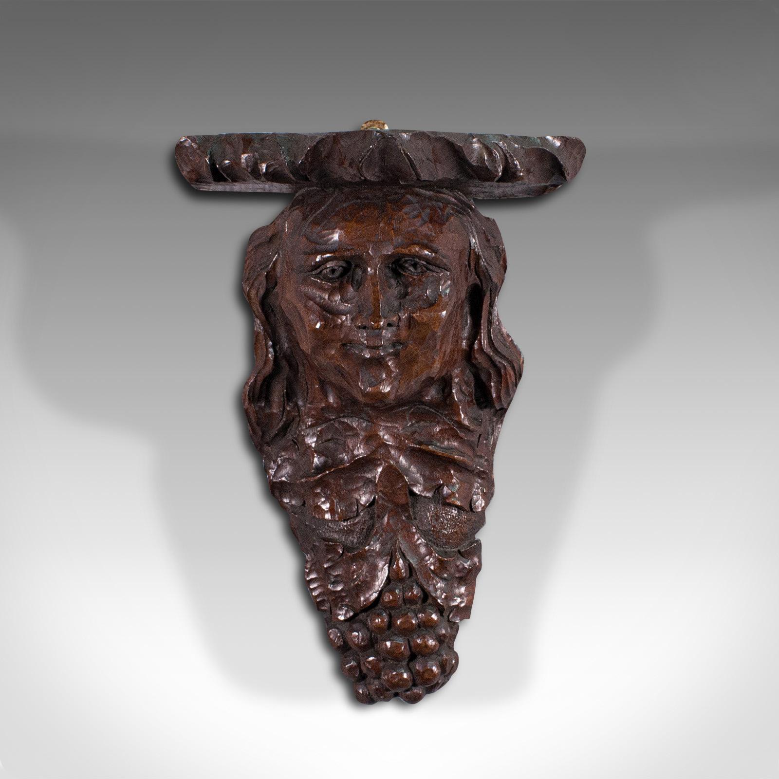 This is an antique decorative sconce. An American, carved oak figural candle bracket, dating to the late 18th century, circa 1800.

Wonderfully naive carving to this fascinating American sconce
Displays a desirable aged patina
Carved oak offers