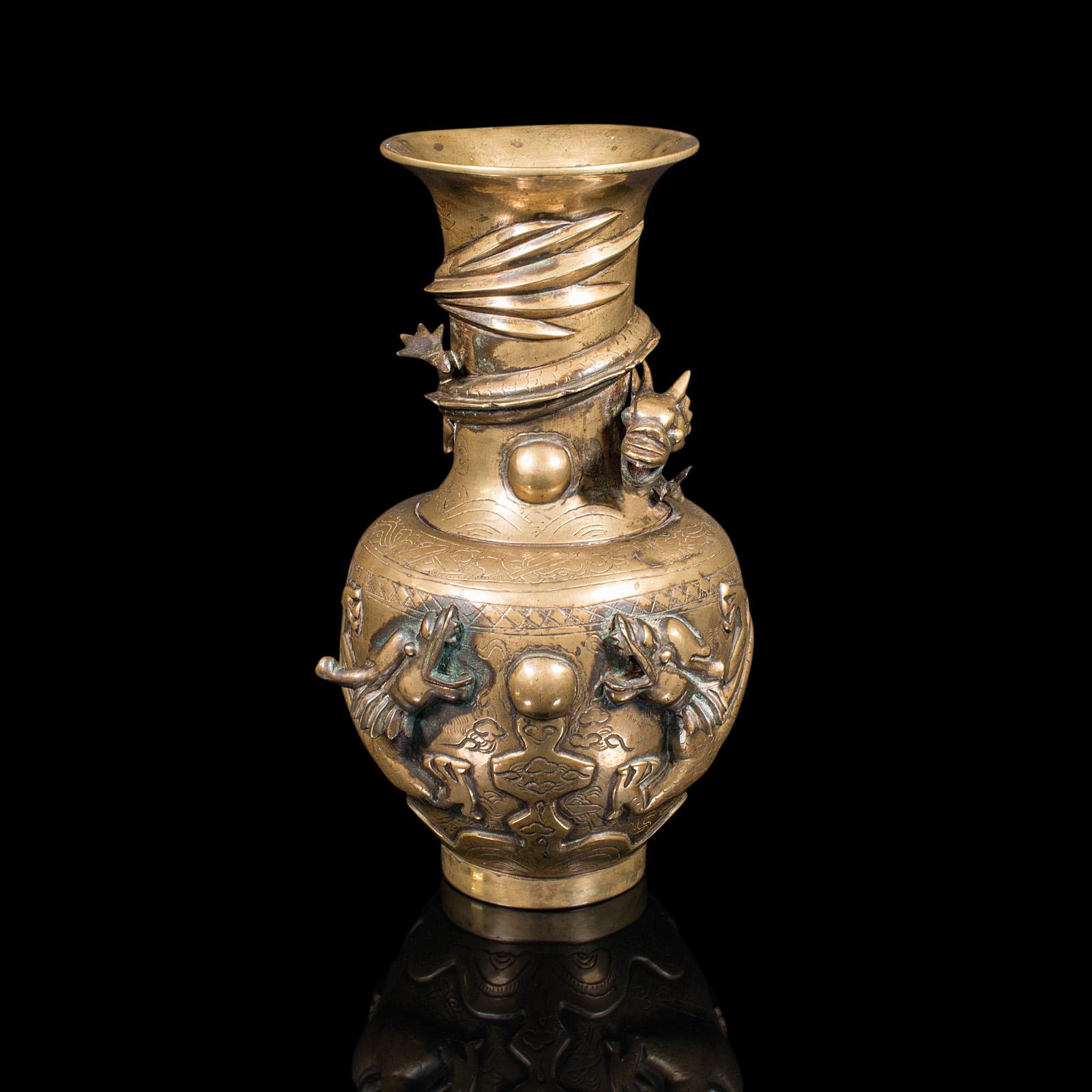 This is an antique decorative vase. A Chinese, brass flower urn with dragon motif, dating to the Victorian period, circa 1880.

Wonderful relief form with appealing colour
Displays a desirable aged patina - minor loss to one foot
Brass urn form