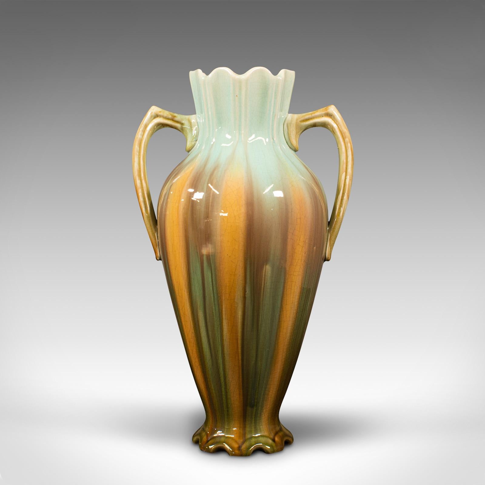 This is an antique decorative vase. A French, ceramic flower urn in Art Nouveau taste, dating to the late Victorian period, circa 1900.

Appealing colors and distinctive foliate form
Displays a desirable aged patina and in good order
Ceramic