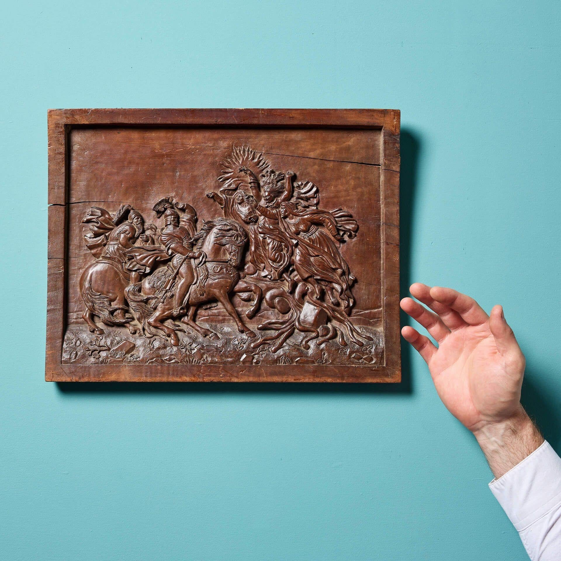 An intricately carved 19th century antique wooden wall panel depicting a mythical or biblical scene. It details what appears to be three mythological beings, possibly witches or sorceresses, attacking two soldiers dressed in armour on