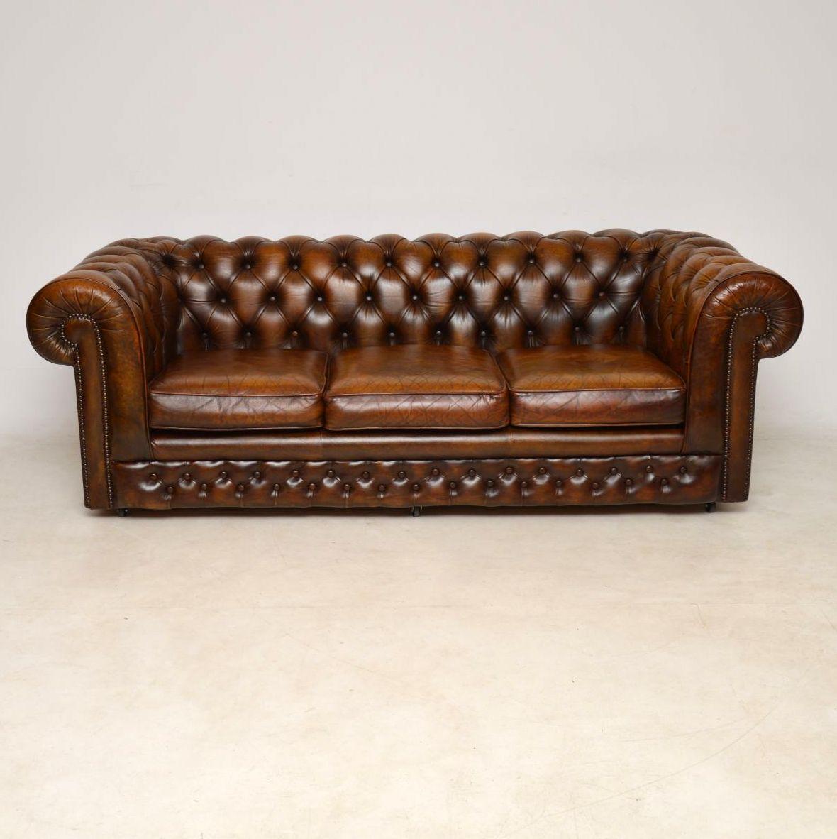 This antique leather three-seat Chesterfield sofa has aged beautifully and consequently has a wonderful color which in turn gives it loads of character. Normally, we have these Chesterfields and most leather items revived, enhanced and polished,
