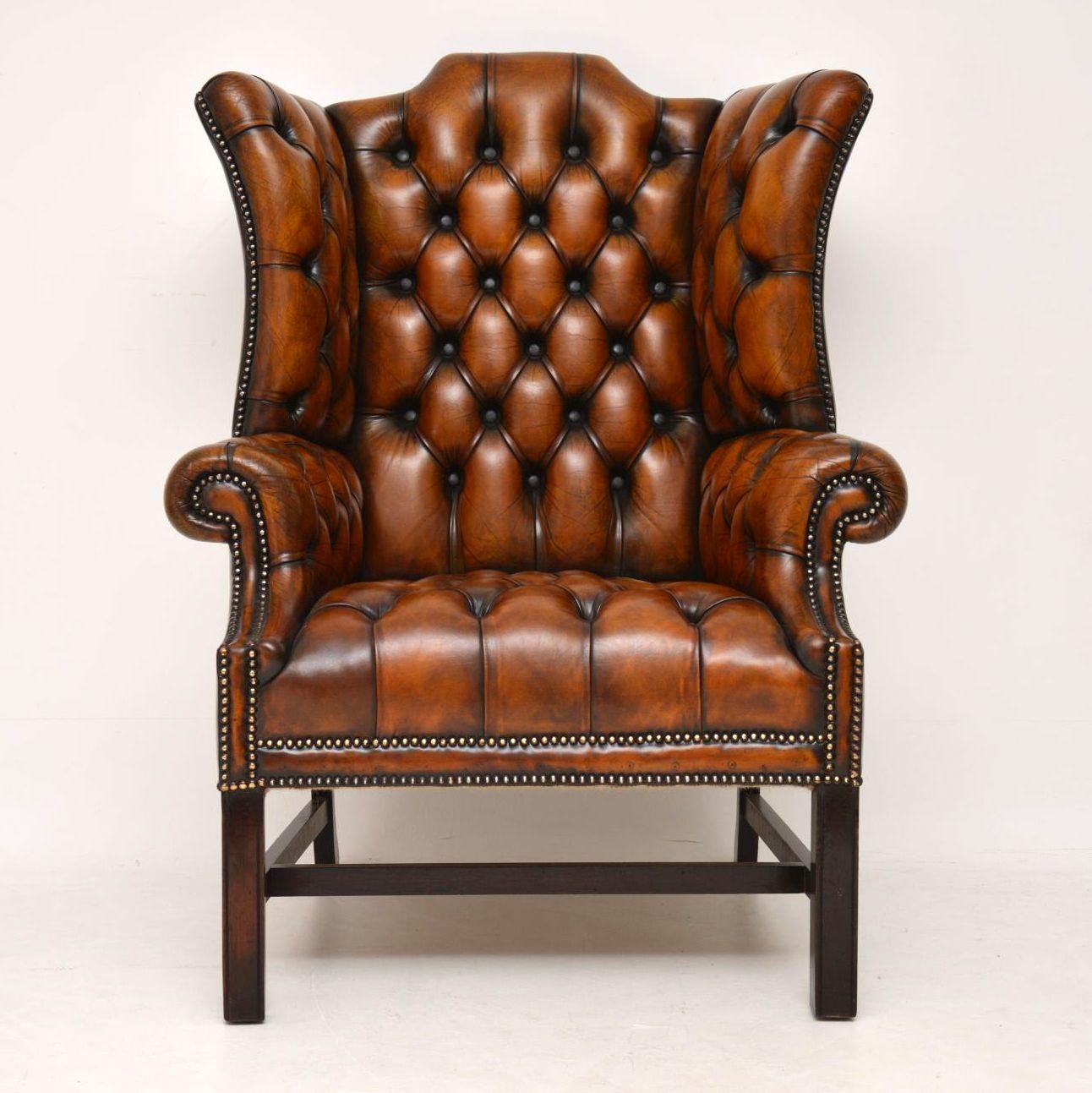 Large antique deep buttoned leather wing armchair in great condition, with loads of character and a lovely original color. This chair is very comfortable, with good back & head support. It has a high hump back, with deep shaped out wings, deep