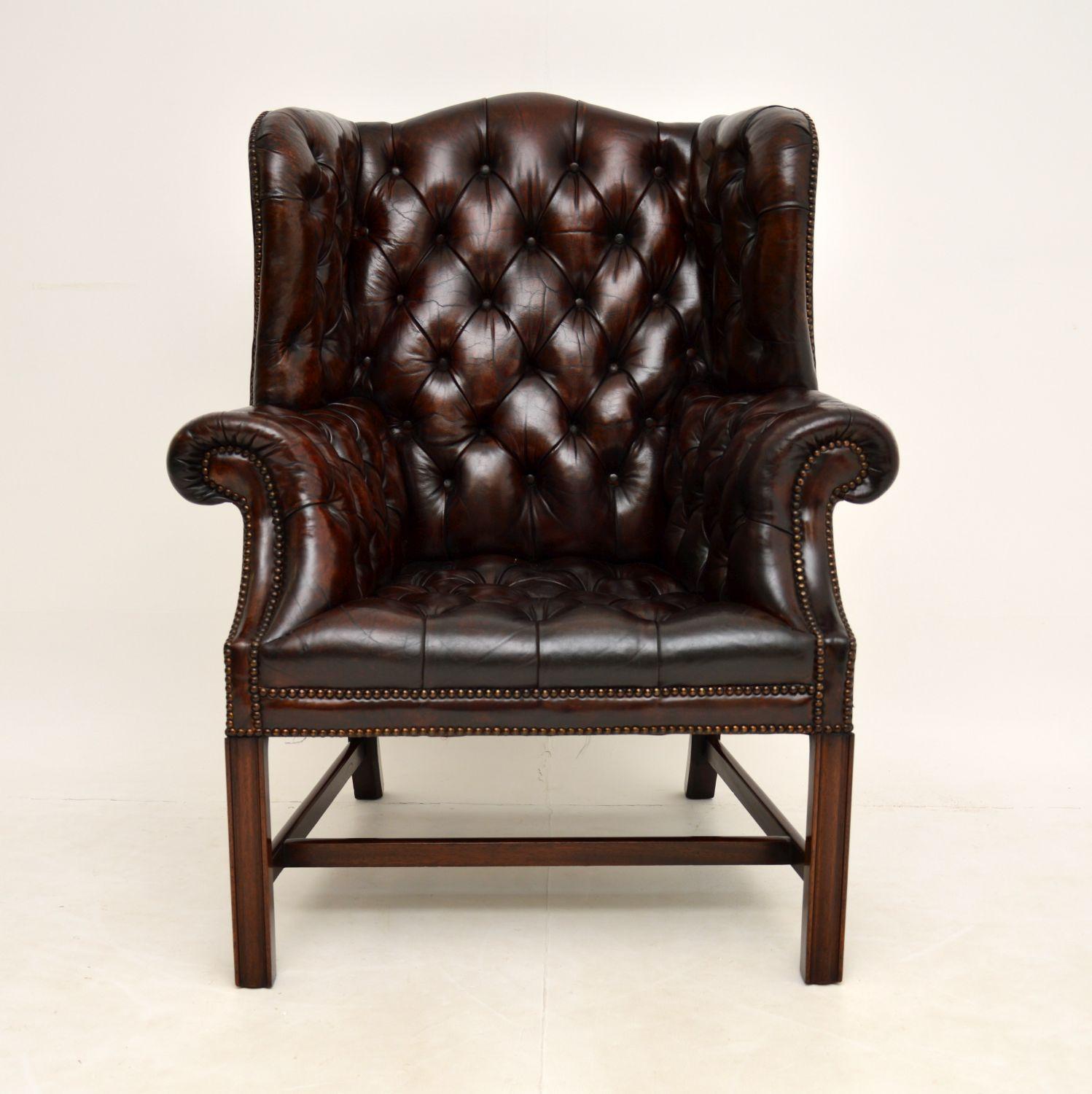 An absolutely stunning antique leather wing back armchair on a solid mahogany base. This is of the utmost quality, it dates from the 1900-1920 period & is Chippendale style.

The design is gorgeous, with a humped back and shapely sides, deep