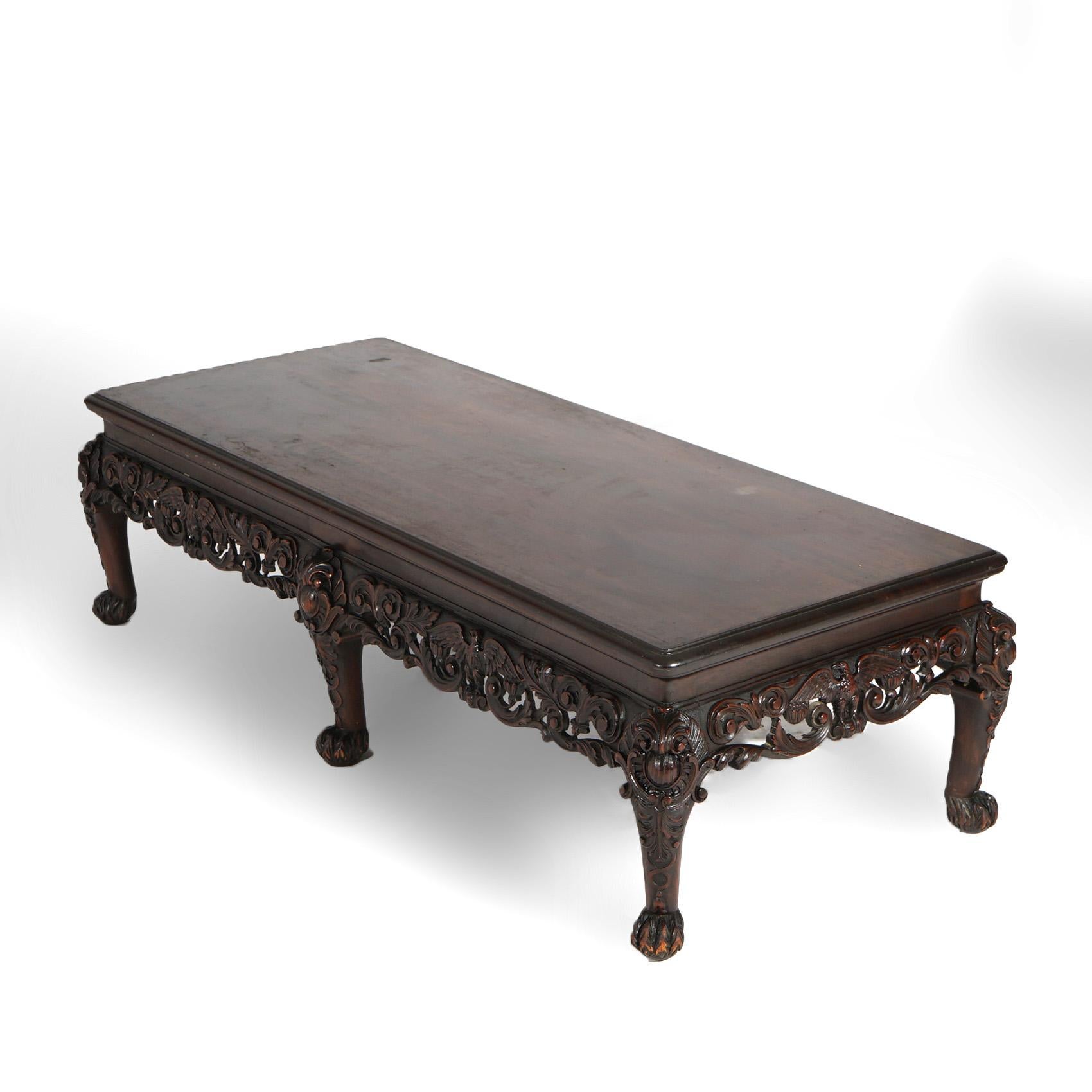 ***Ask About Discounted In-House Shipping***
An antique low table offers mahogany construction with deeply carved and pierced skirt having scroll, foliate, and eagle (phoenix) elements, raised on cabriole legs terminating in paw feet, marked HZM &